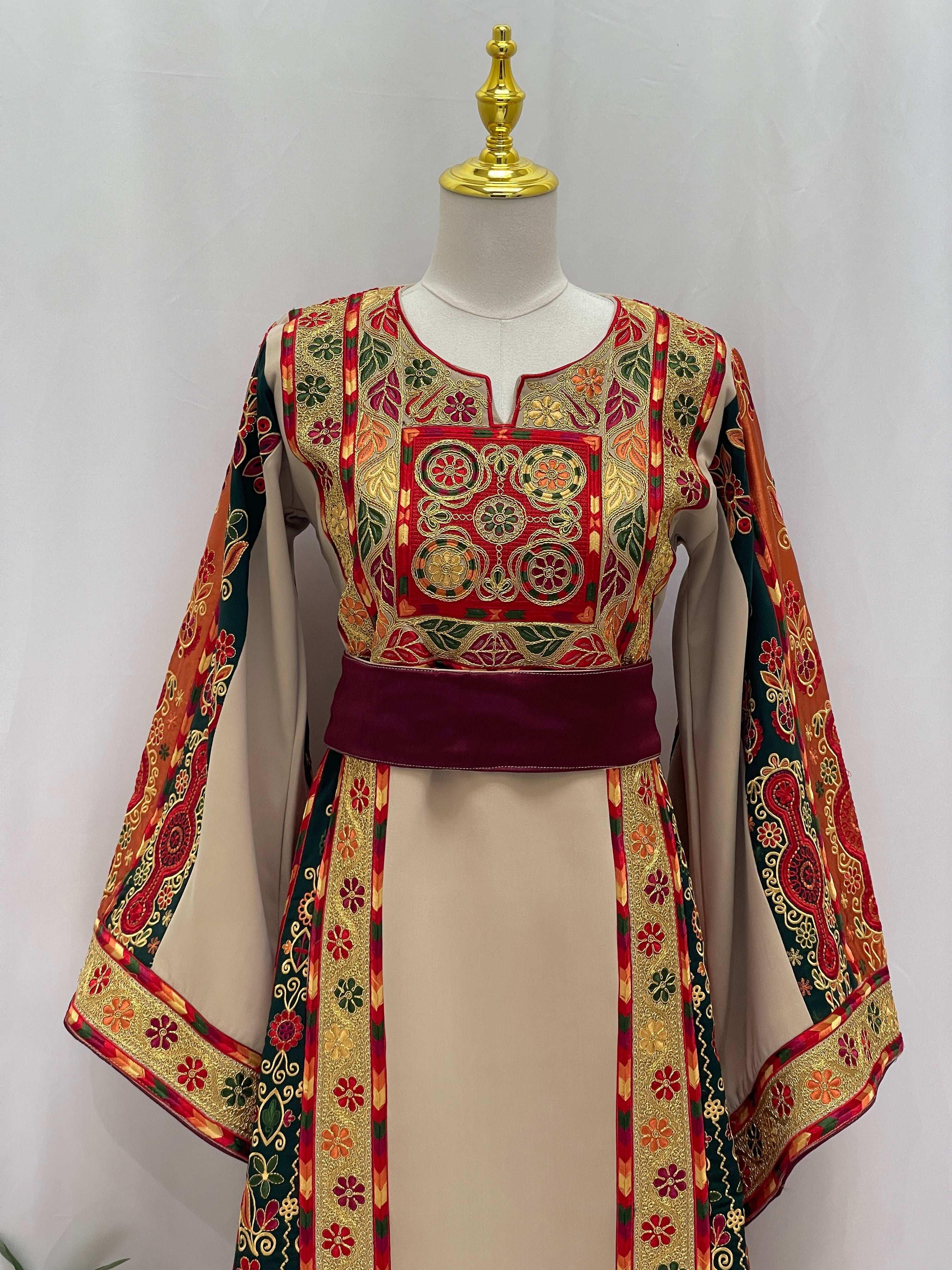 Embroidered traditional dress by Palestinian Elegance featuring Falsteen Kasab Malaka design with intricate red and gold patterns