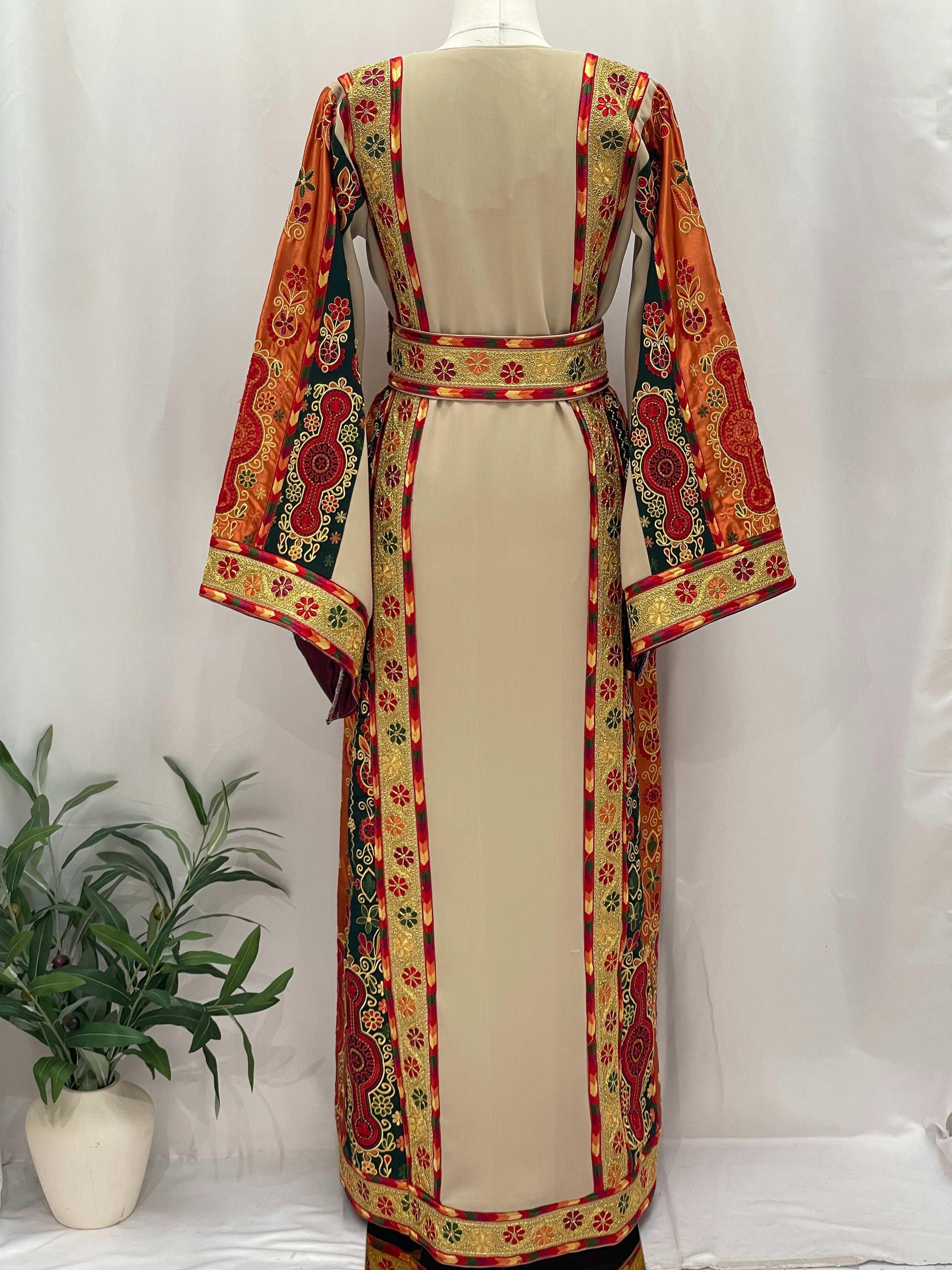 Embroidered Falsteen Kasab Malaka dress by Palestinian Elegance with intricate red and gold patterns on beige fabric