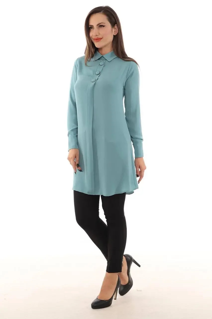 Palestinian Elegance formal tunic for women in teal with long sleeves and button details styled with black leggings and heels