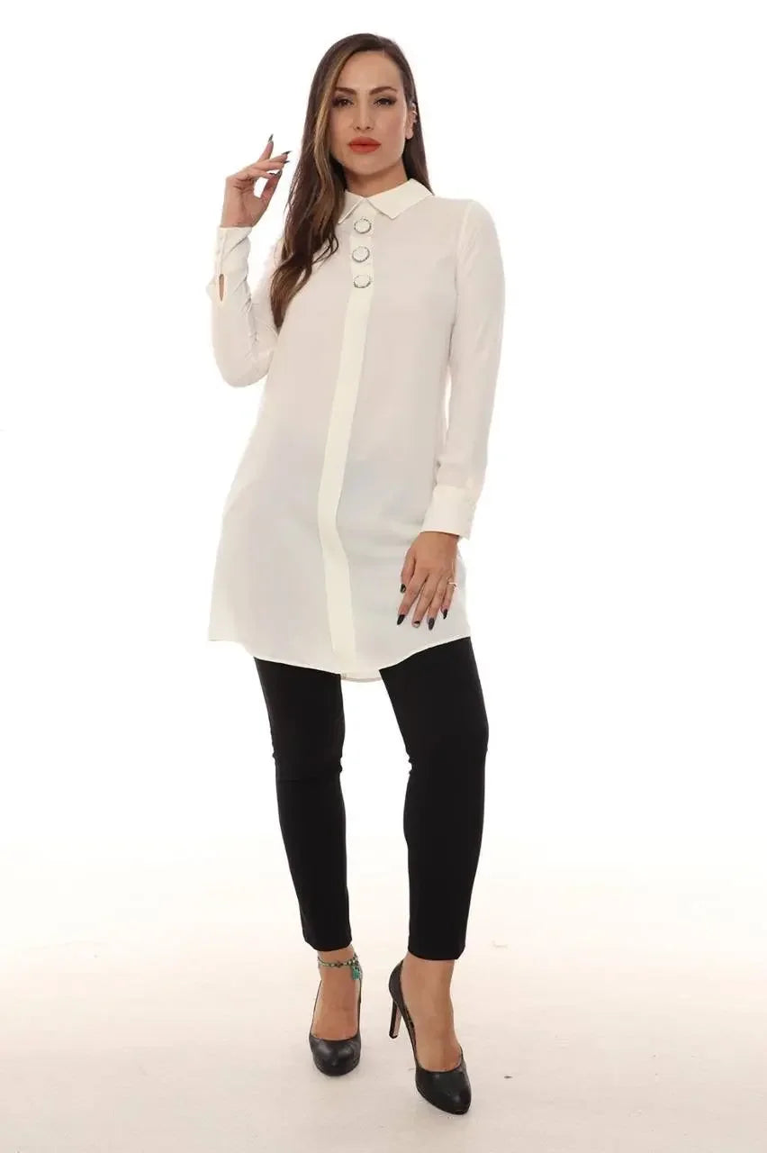 Palestinian Elegance formal tunic for women in white with long sleeves and button details worn with black pants