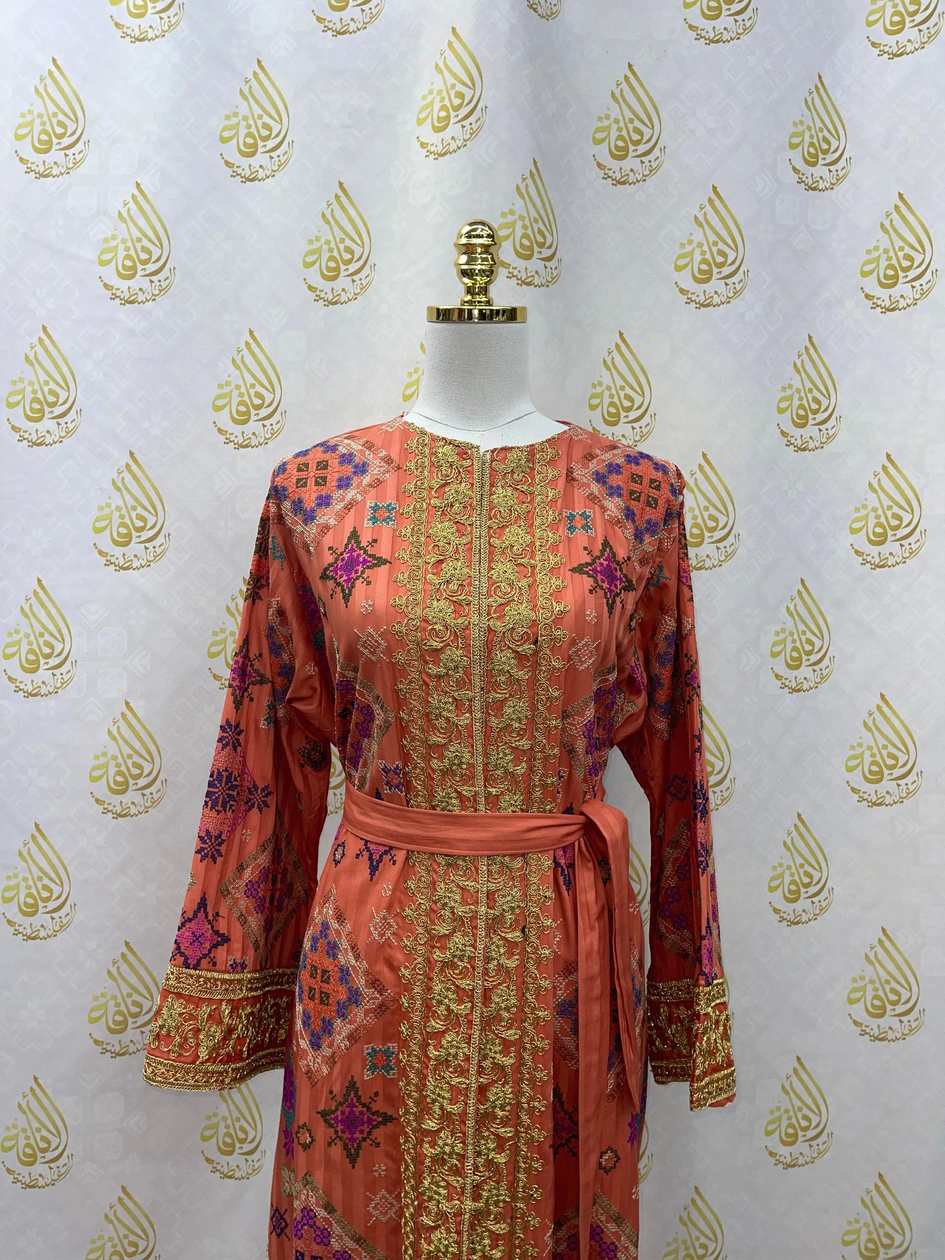 Palestinian Elegance Gabani embroidered long cardigan in orange with intricate gold and purple embroidery and waist tie