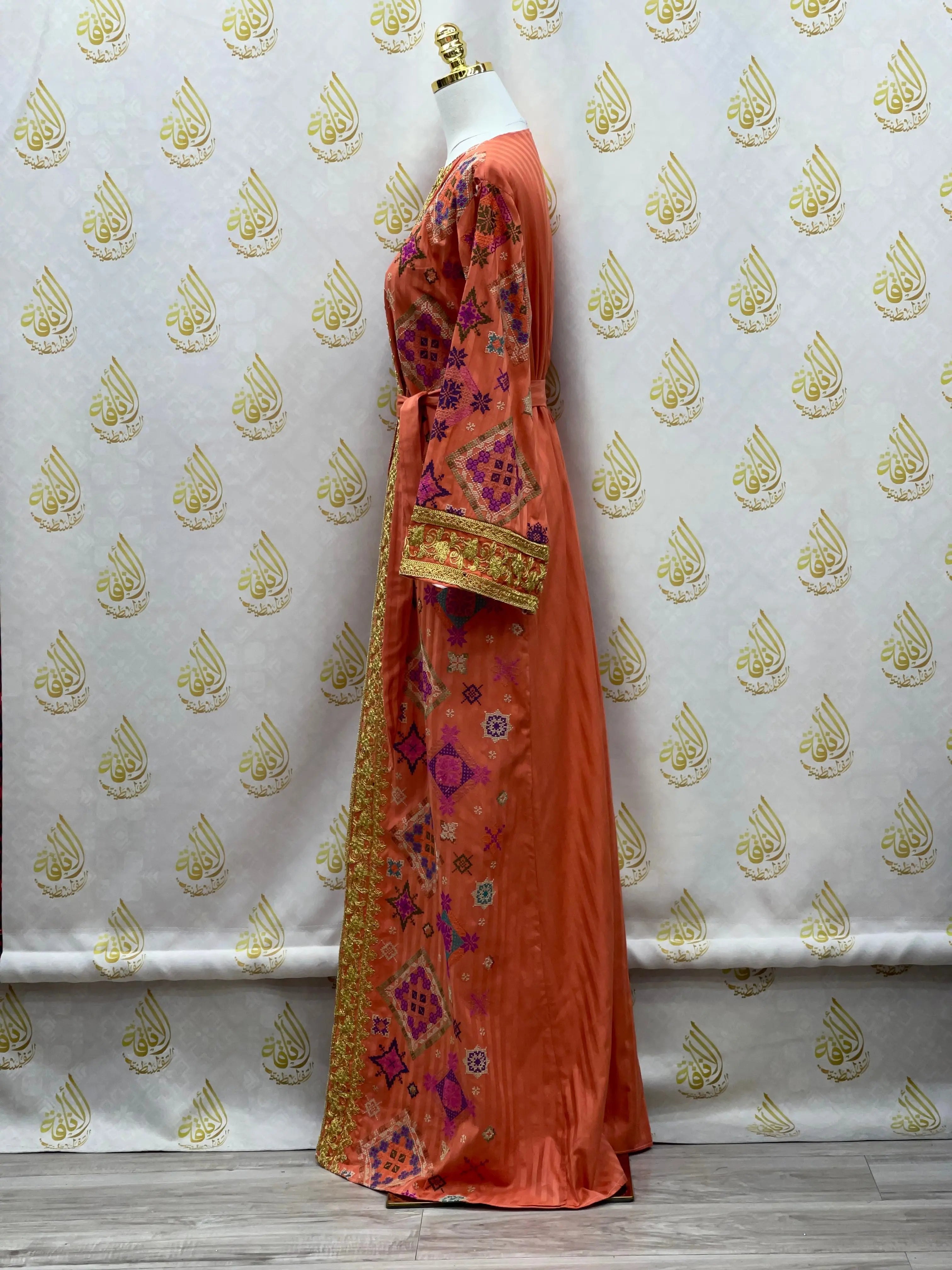 Gabani embroidered long cardigan in orange with intricate pink and gold designs on a mannequin