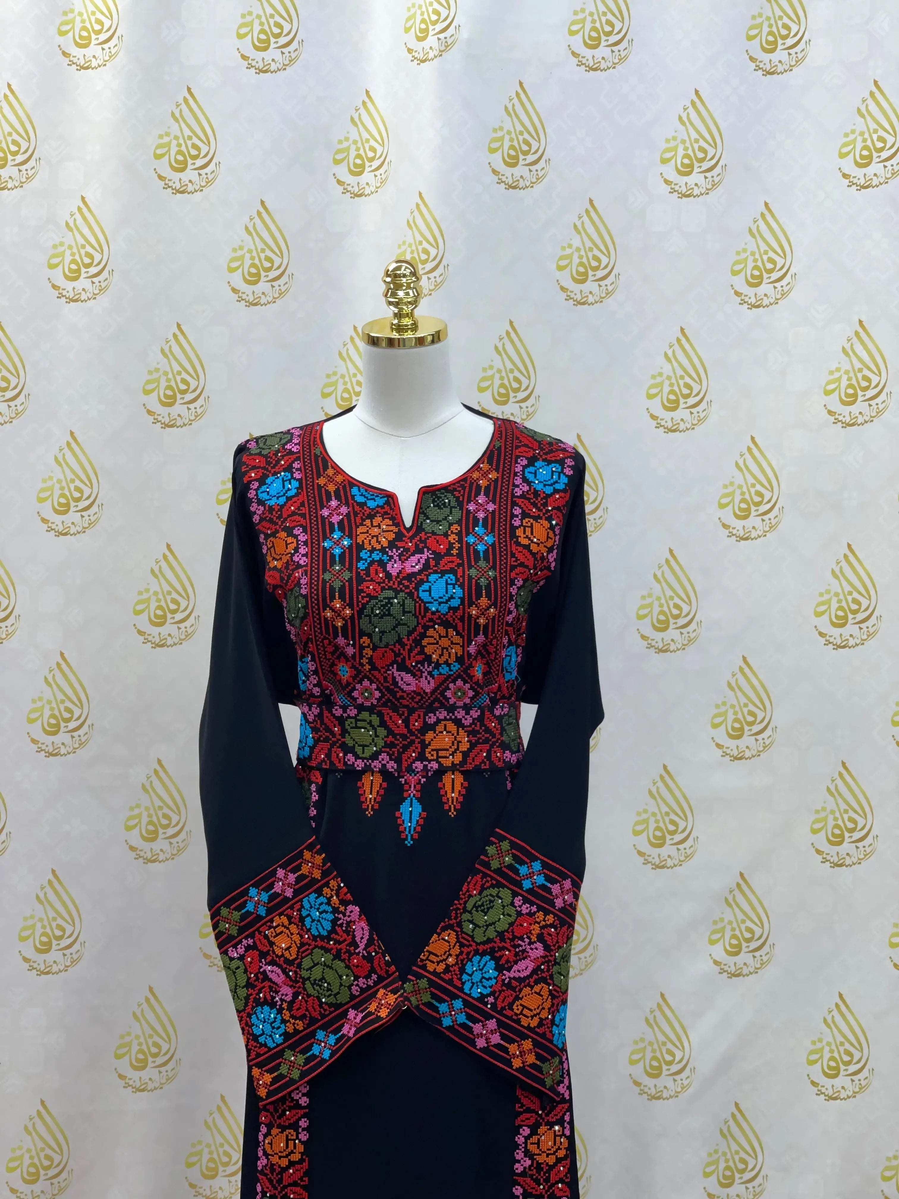 Palestinian Elegance hand-embroidered abaya with vibrant multicolor floral embroidery on black fabric