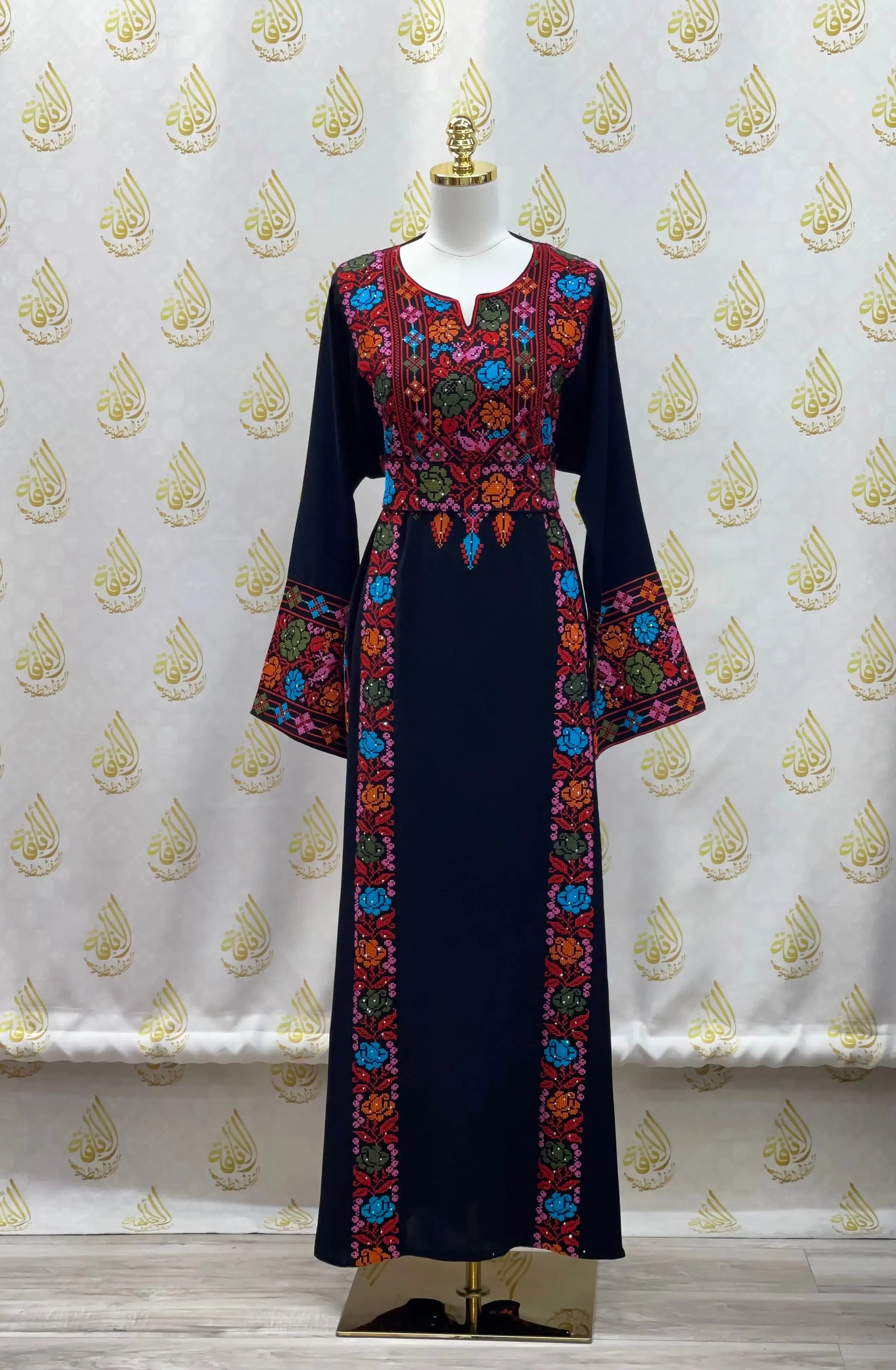 Palestinian Elegance hand-embroidered abaya in navy with colorful floral embroidery on front and sleeves