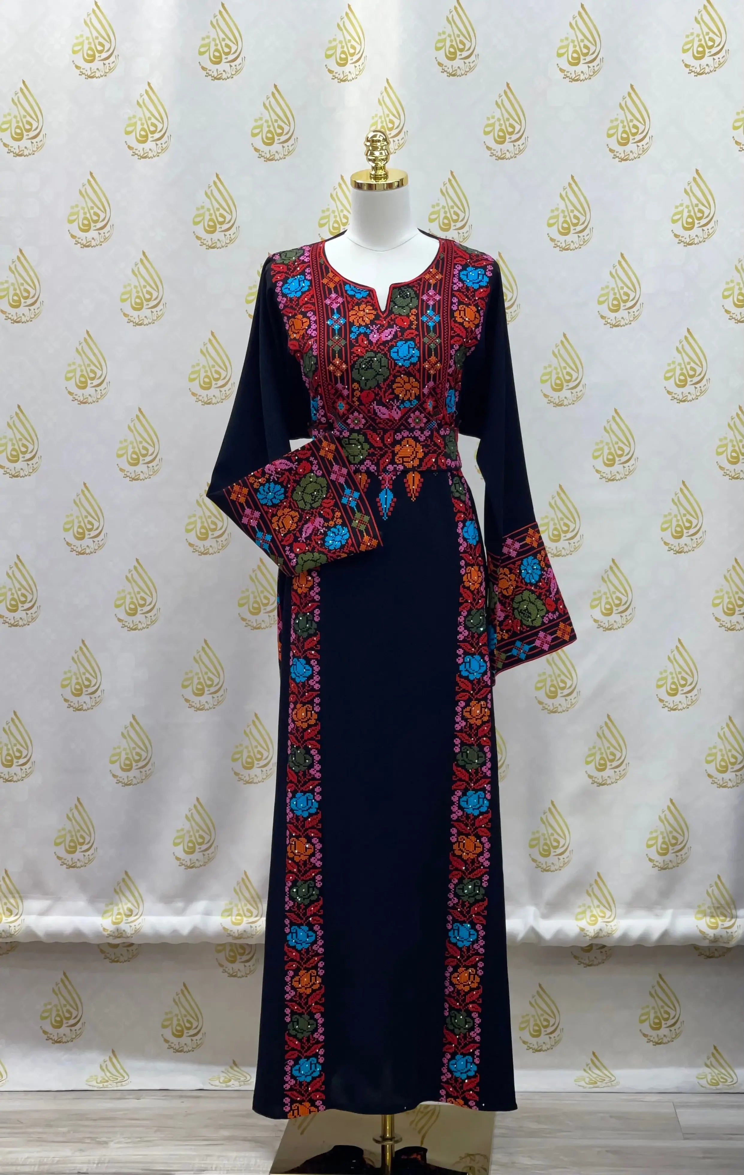 Palestinian Elegance hand-embroidered abaya in navy with vibrant multicolor floral embroidery on front, sleeves, and hem