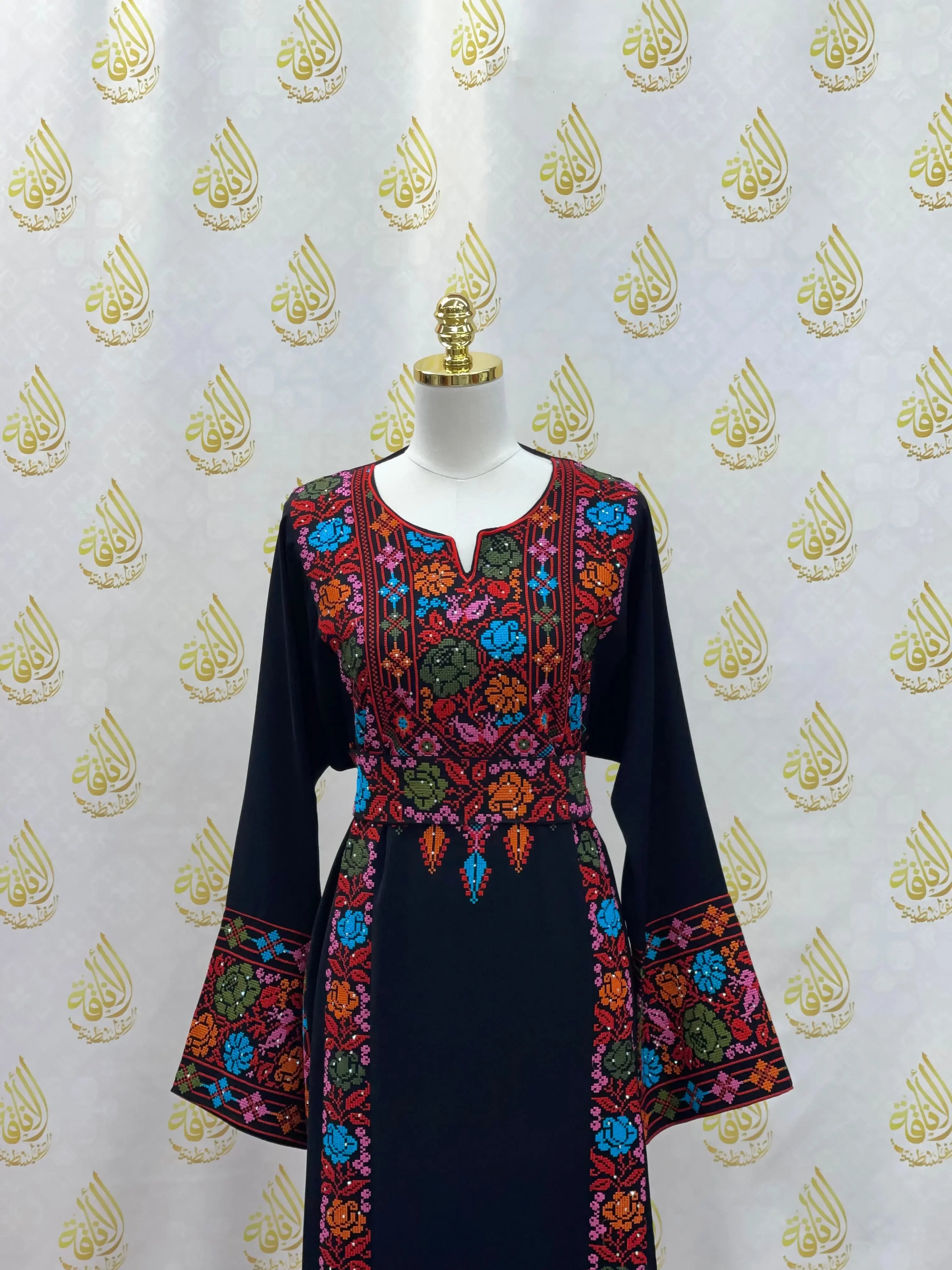 Palestinian Elegance hand-embroidered abaya with colorful floral designs on black fabric