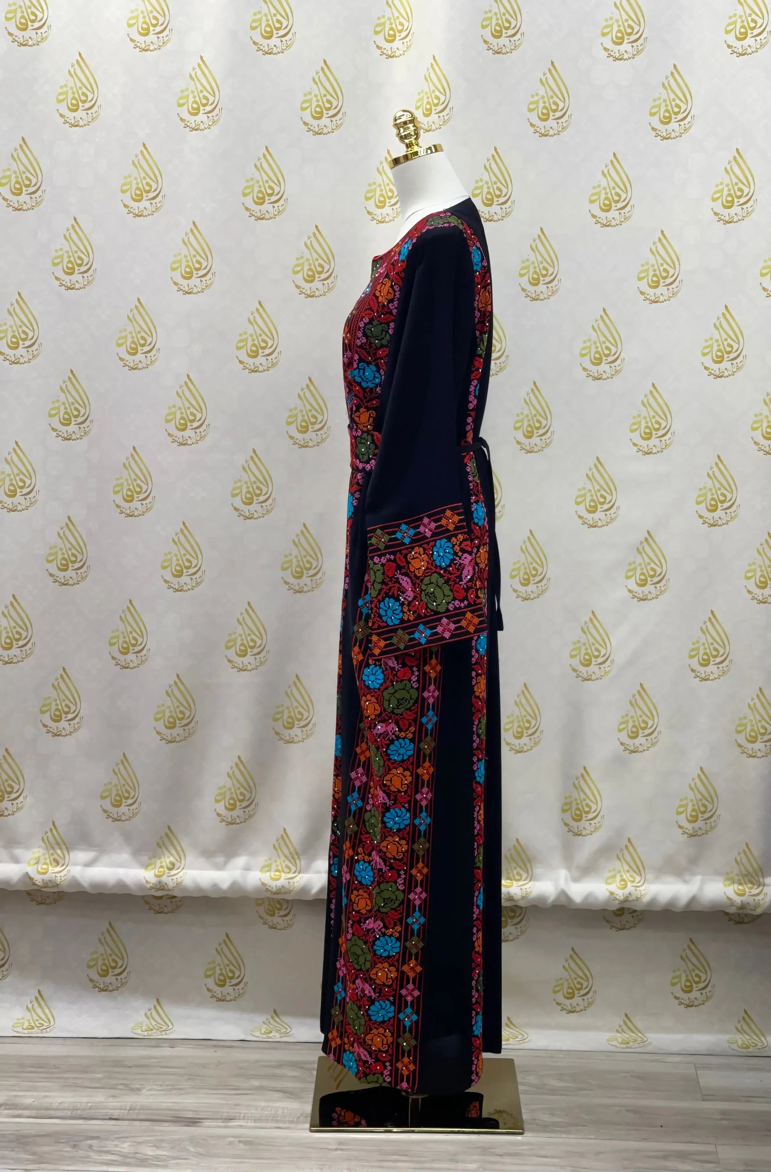 Palestinian Elegance hand-embroidered abaya with colorful floral embroidery on black fabric