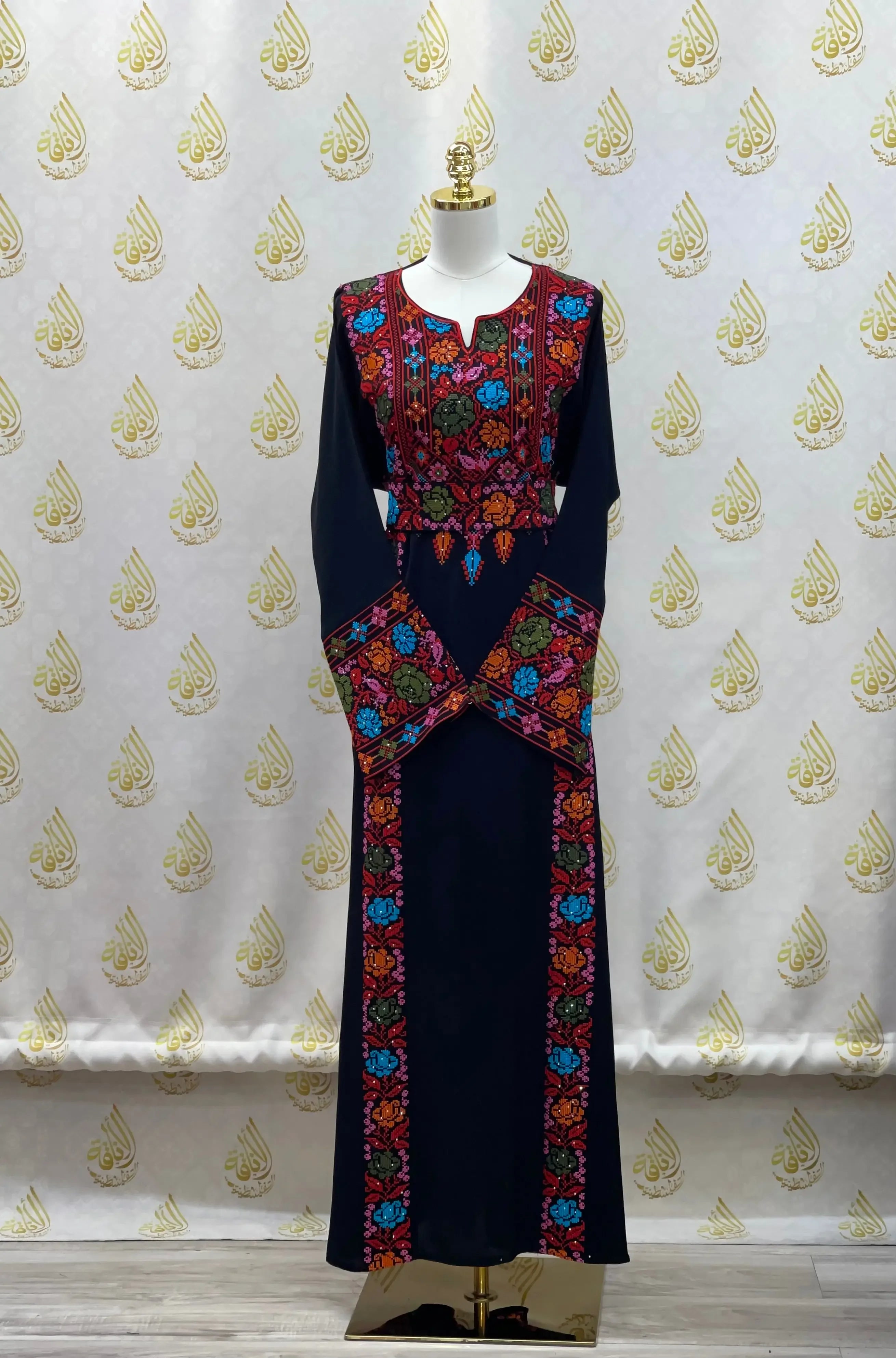 Palestinian Elegance hand-embroidered abaya in navy blue with colorful floral embroidery on chest, sleeves, and front