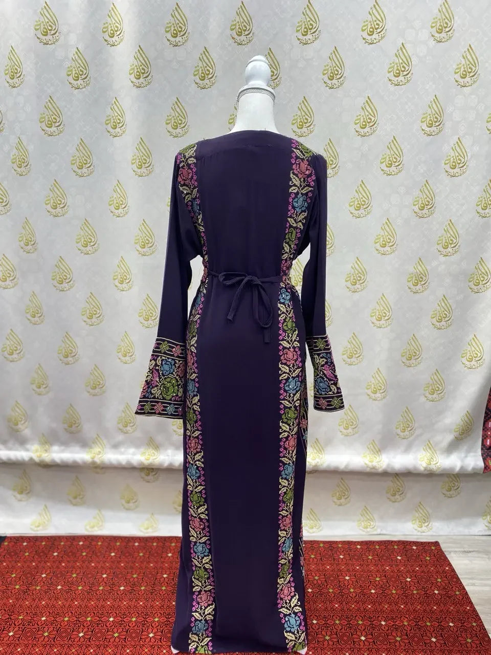 Palestinian Elegance hand-embroidered abaya in deep purple with floral embroidery on sides and sleeves