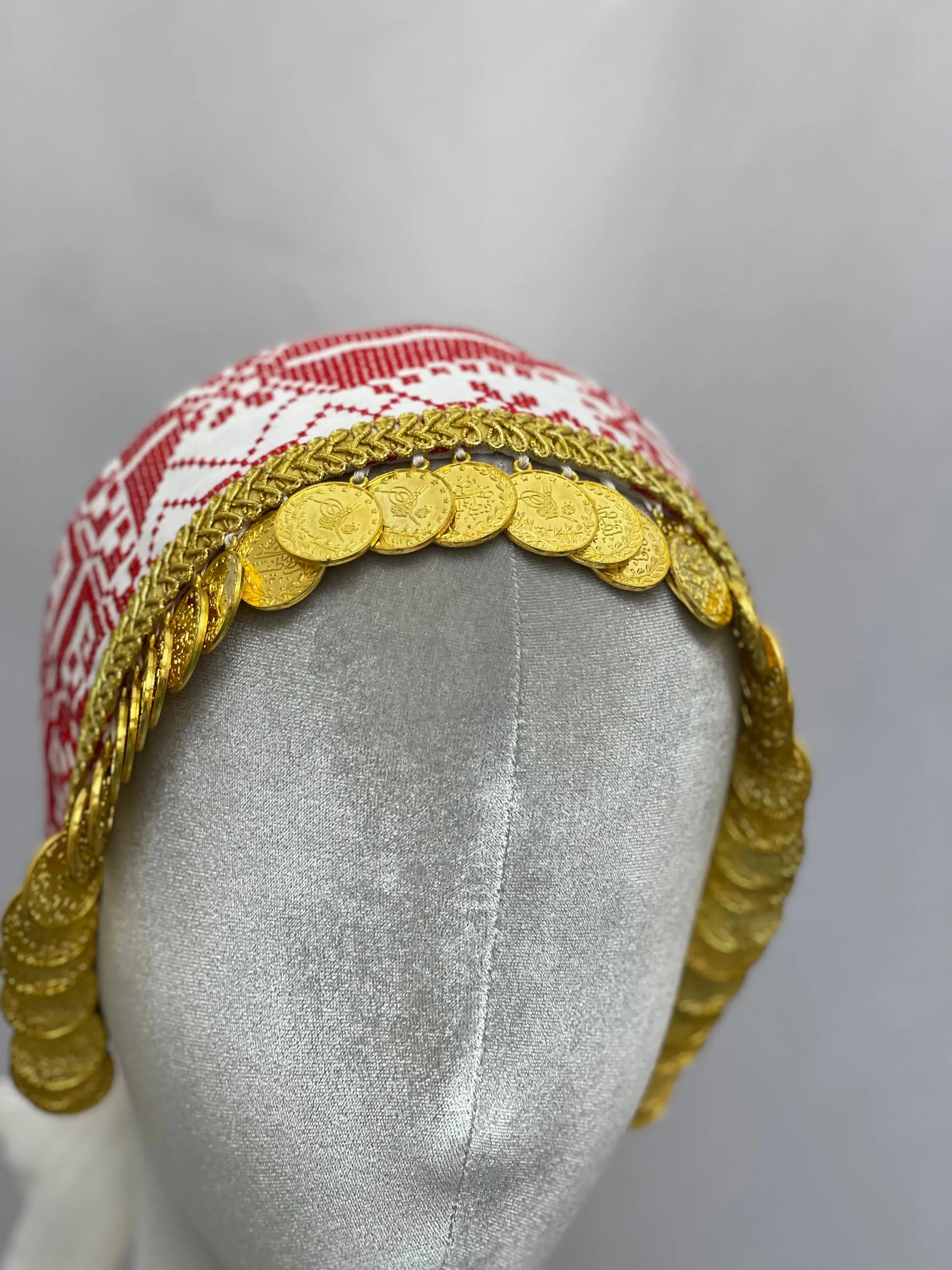 Hand embroidered tatreez headscarf with red and white patterns and gold coin embellishments