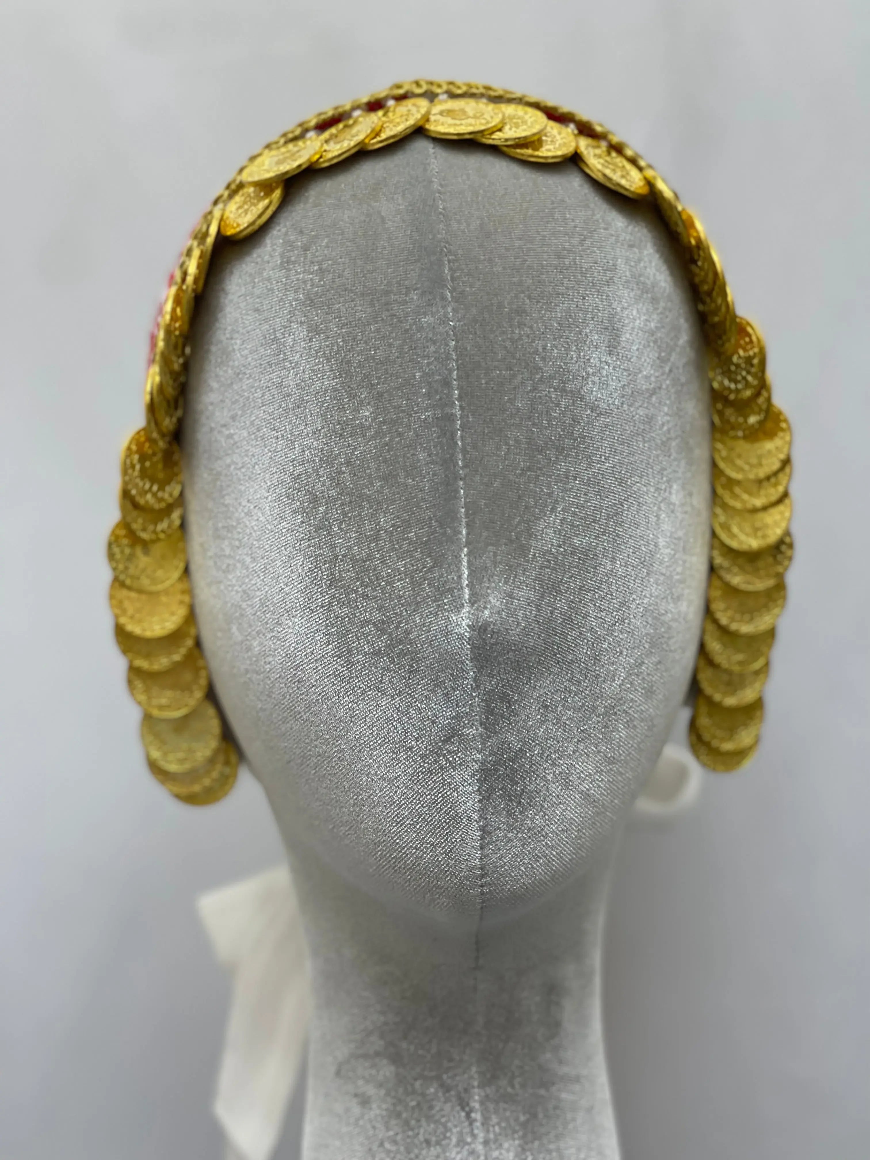 Hand embroidered tatreez headscarf with gold coin embellishments displayed on a silver mannequin head