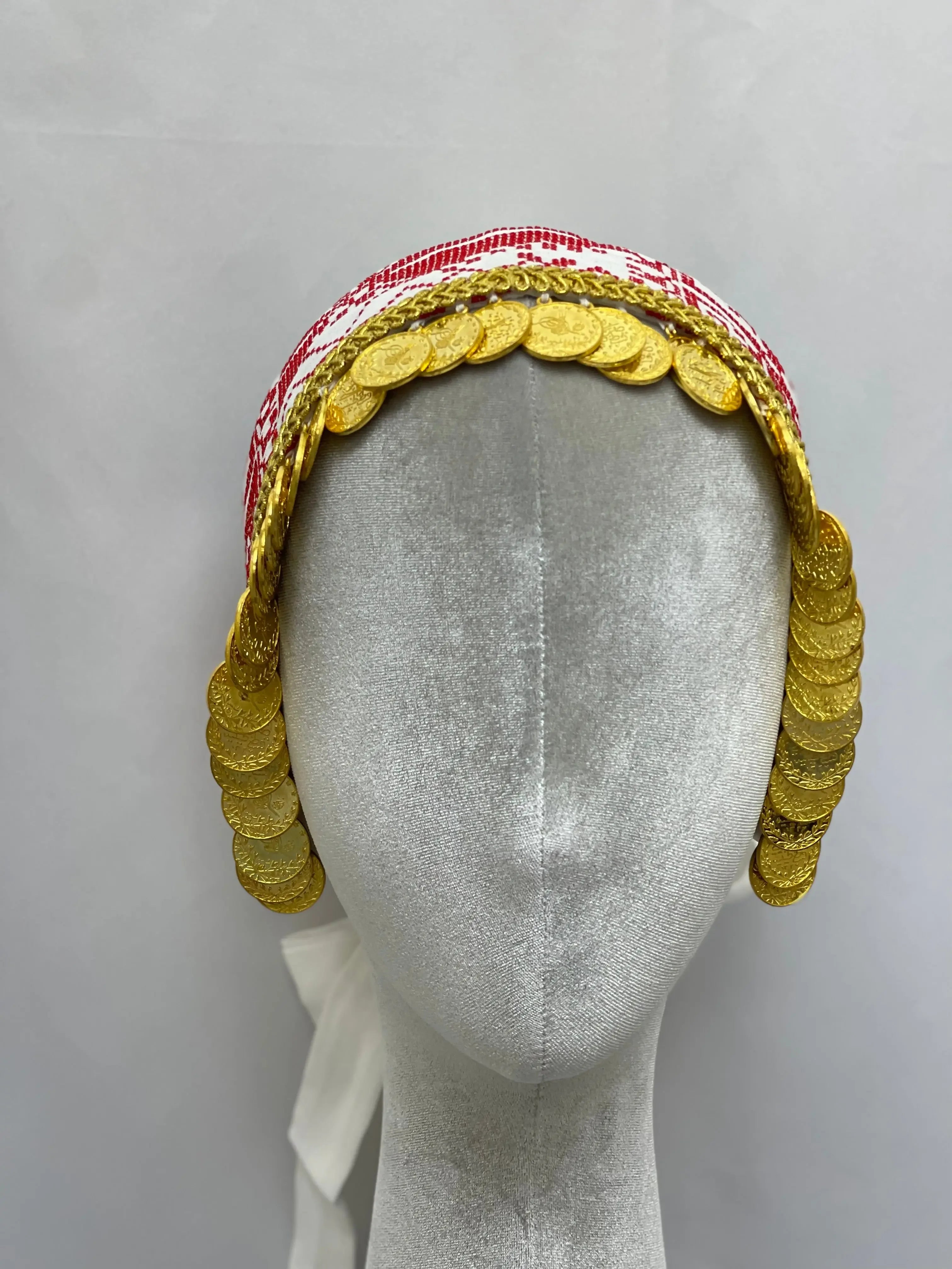 Hand embroidered tatreez headscarf with gold coin detailing displayed on mannequin head