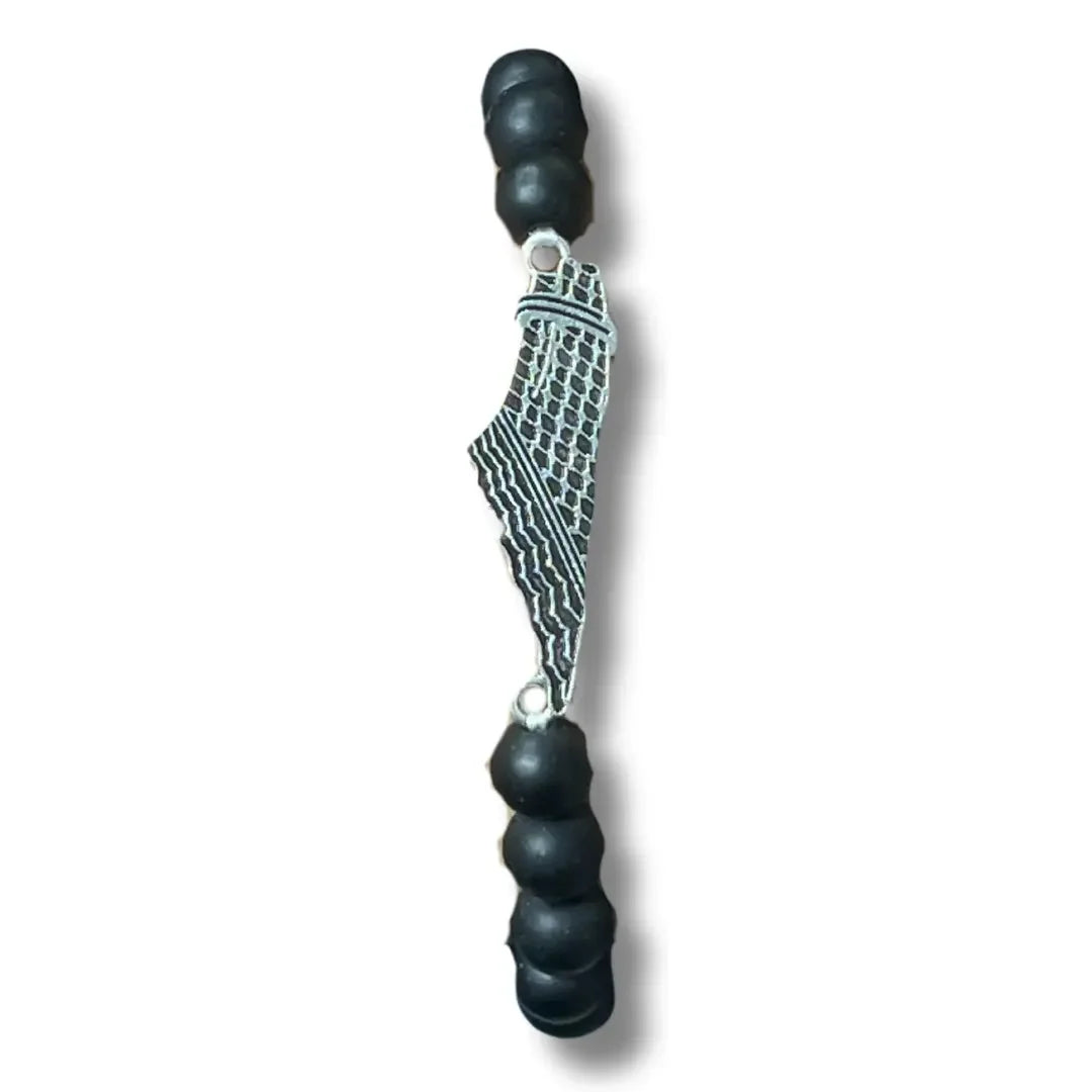 Handcrafted kuffiyeh bracelet featuring black beads and a silver-tone kuffiyeh design charm