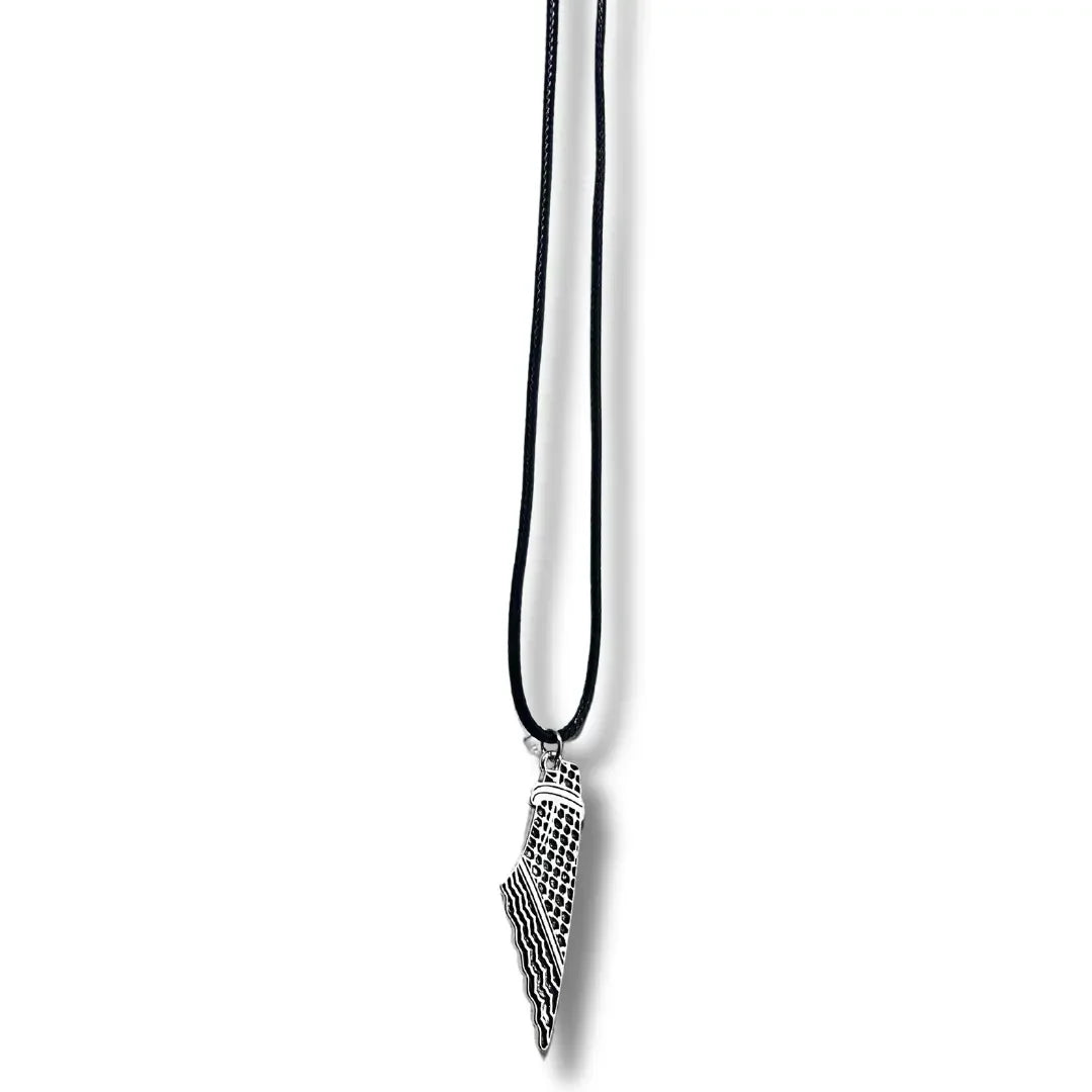 Handcrafted kuffiyeh necklace with black cord and silver pendant featuring traditional Palestinian design