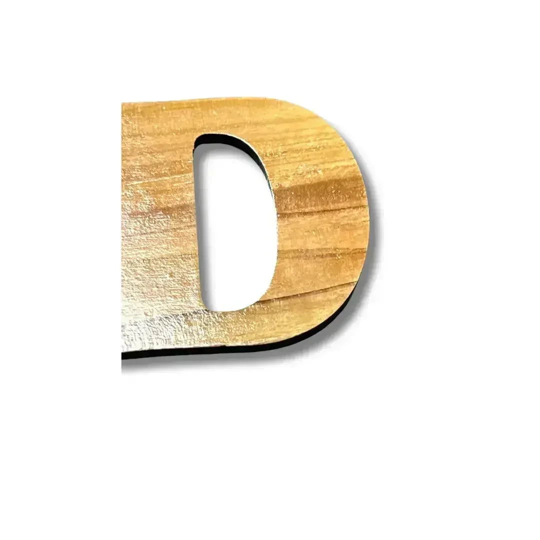 Close-up of a wooden letter D from a handmade Arabic keychain by Palestinian Elegance