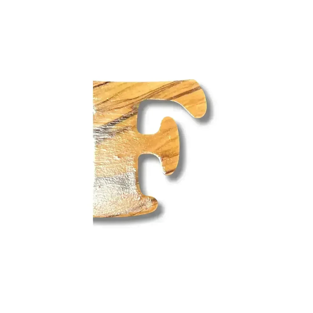 Close-up view of wooden handmade Arabic love keychain letter F from Palestinian Elegance accessories