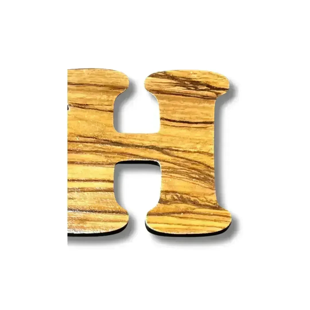 Handmade Arabic love keychain wooden letter H by Palestinian Elegance with natural grain texture