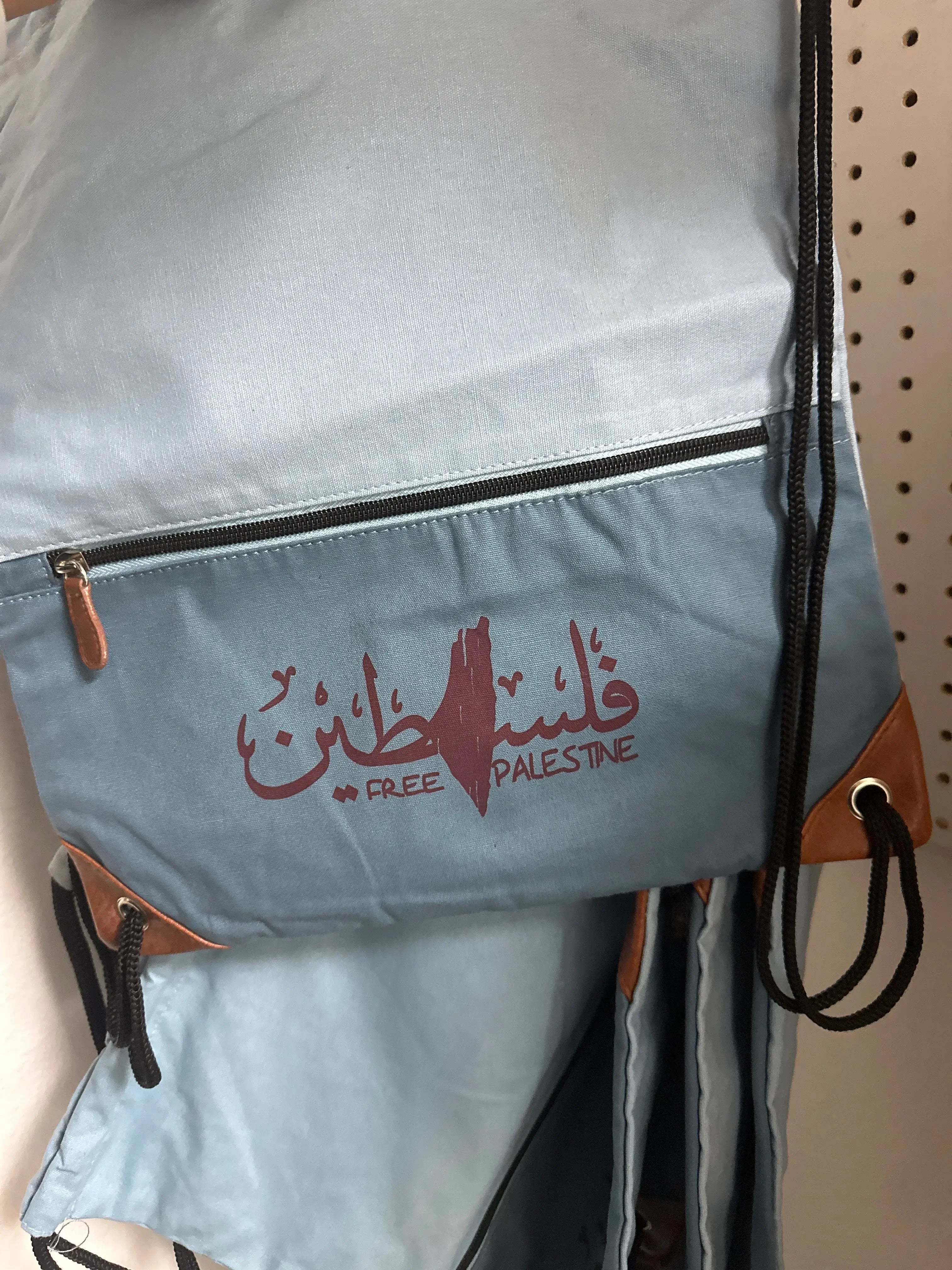 Palestinian elegance handmade Palestine backpack in light blue with Free Palestine design and black drawstring straps