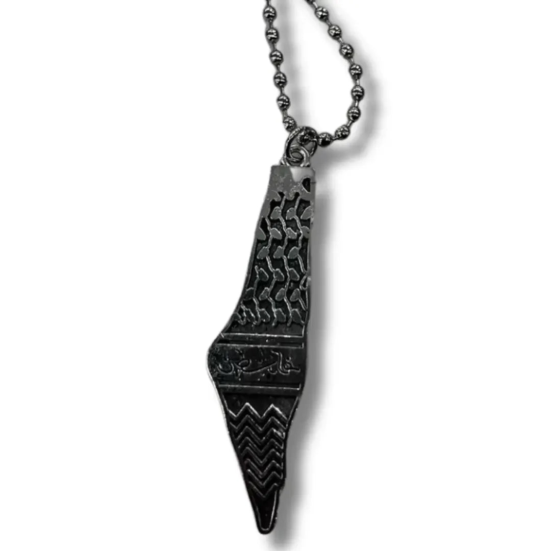 Handmade Palestinian silver necklace with detailed engraved pendant on a beaded chain