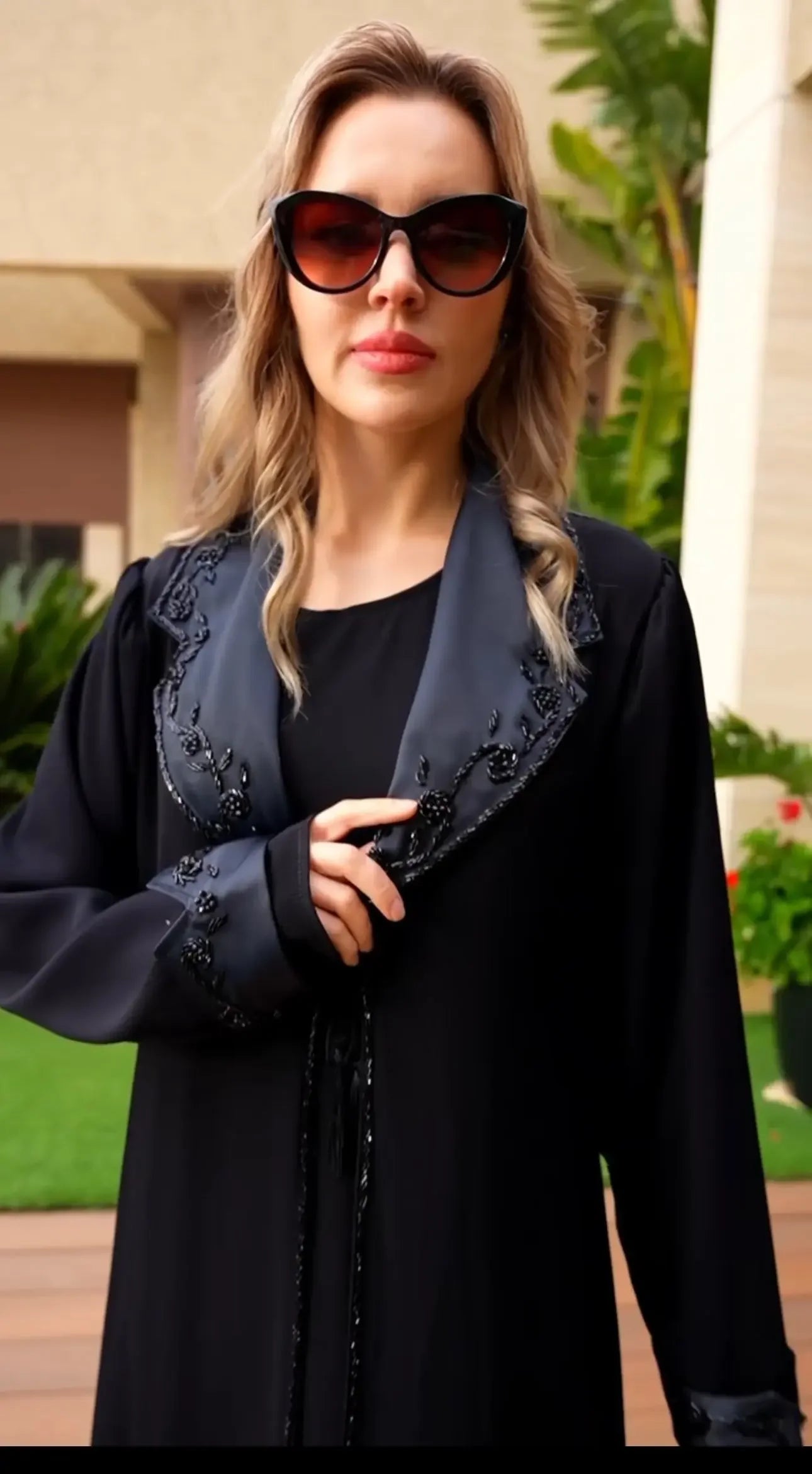 Palestinian Elegance black abaya featuring handmade sewn bead crafts on collar and cuffs