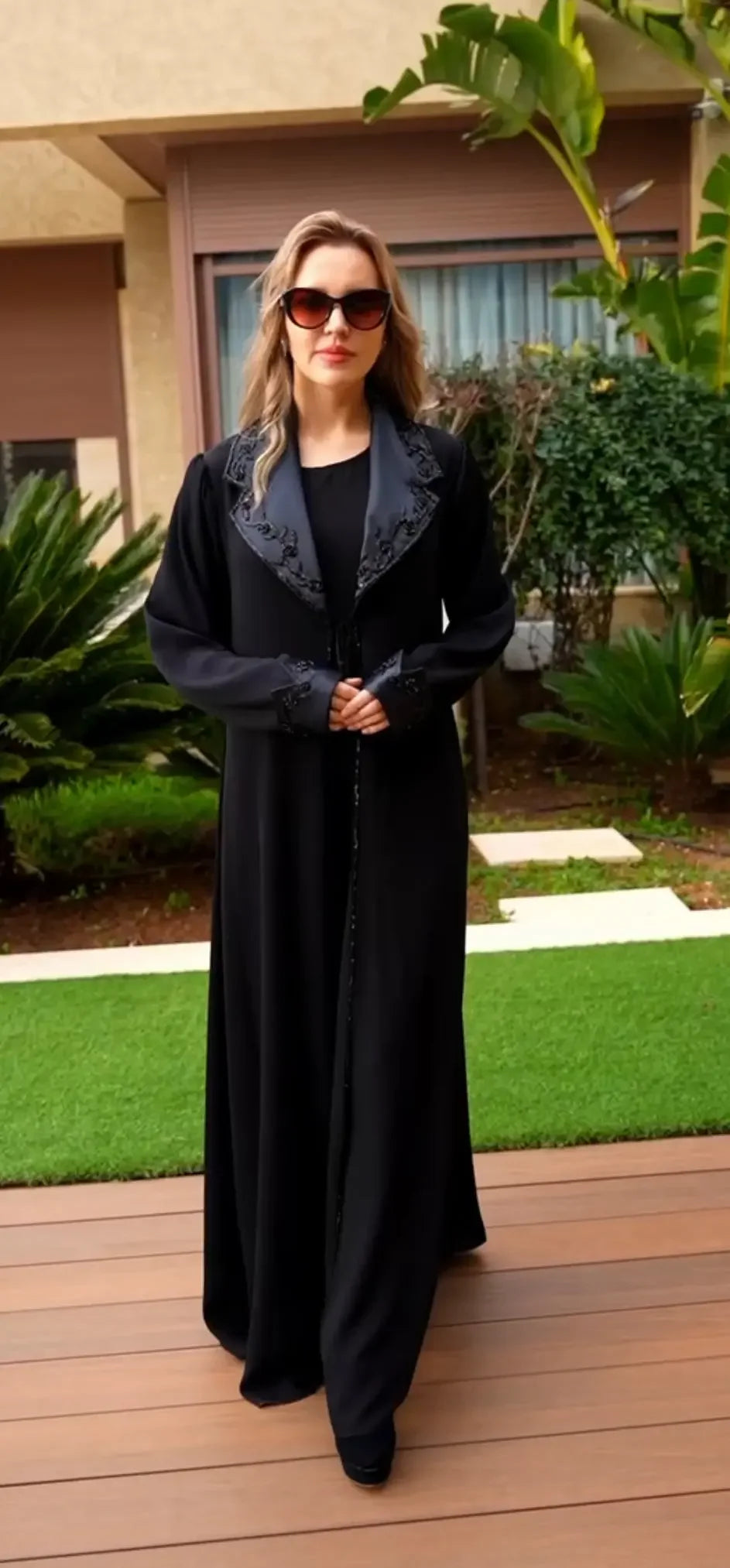 Palestinian Elegance black abaya featuring intricate handmade sewn bead crafts on collar and cuffs