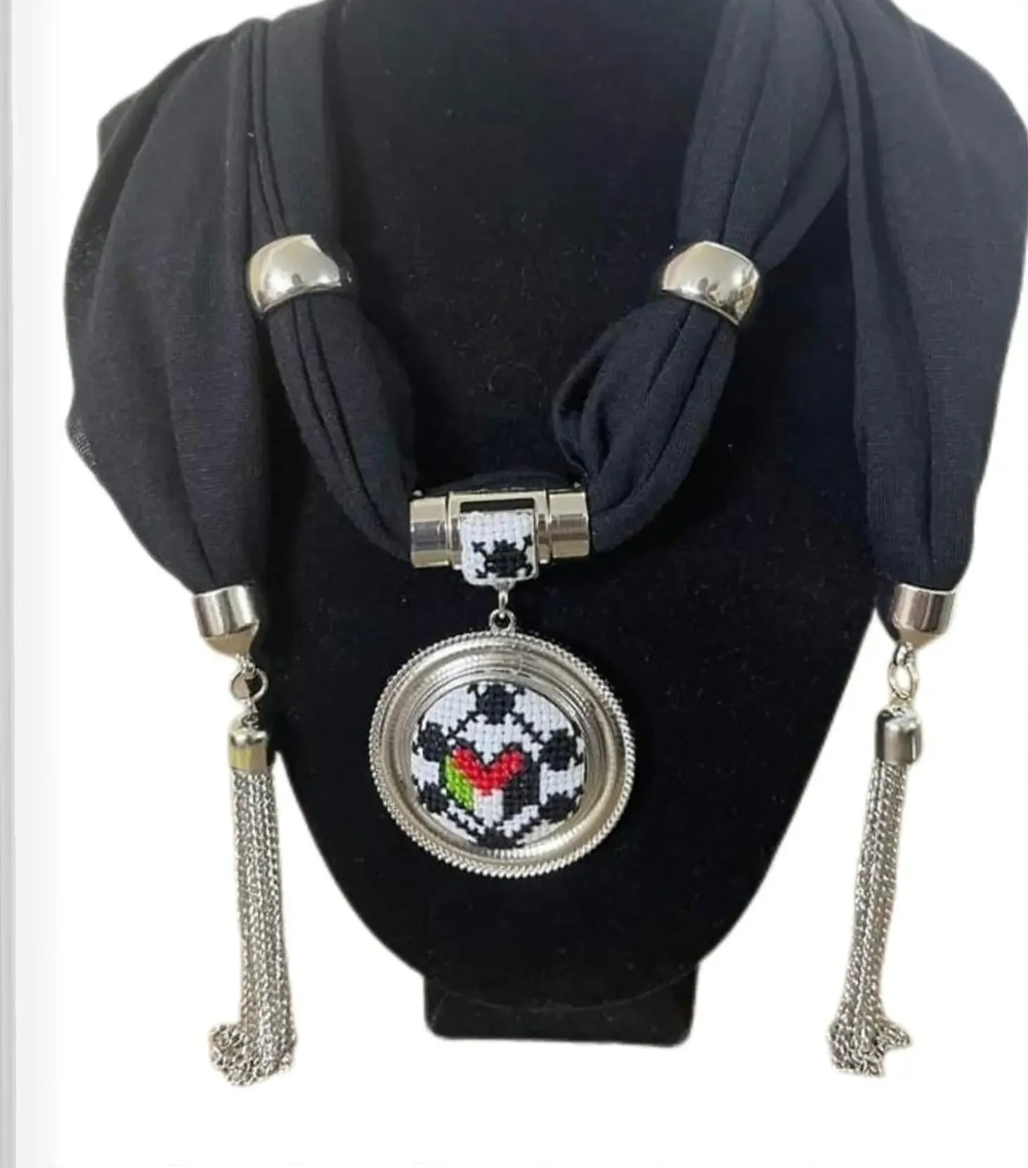 Palestinian Elegance heritage embroidered scarf with black fabric and silver pendant featuring colorful traditional embroidery