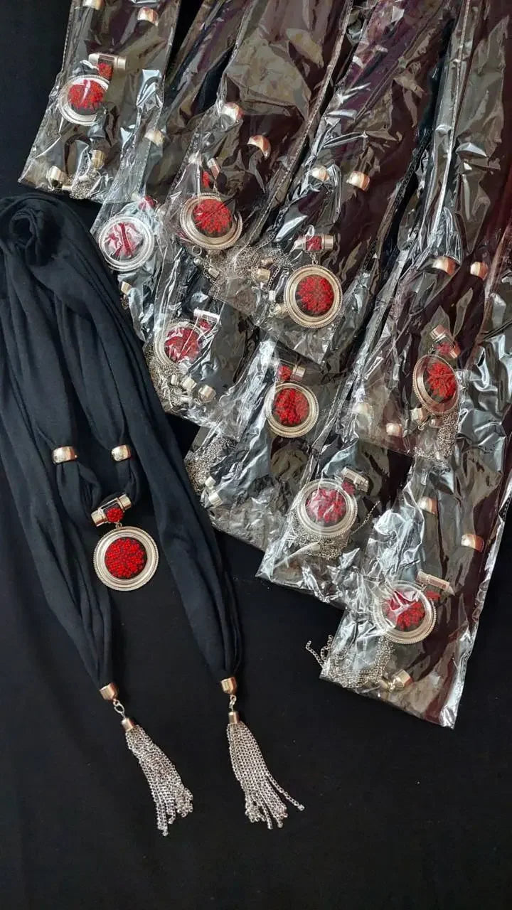 Palestinian Elegance heritage embroidered scarf with red embroidery and silver tassels in black fabric