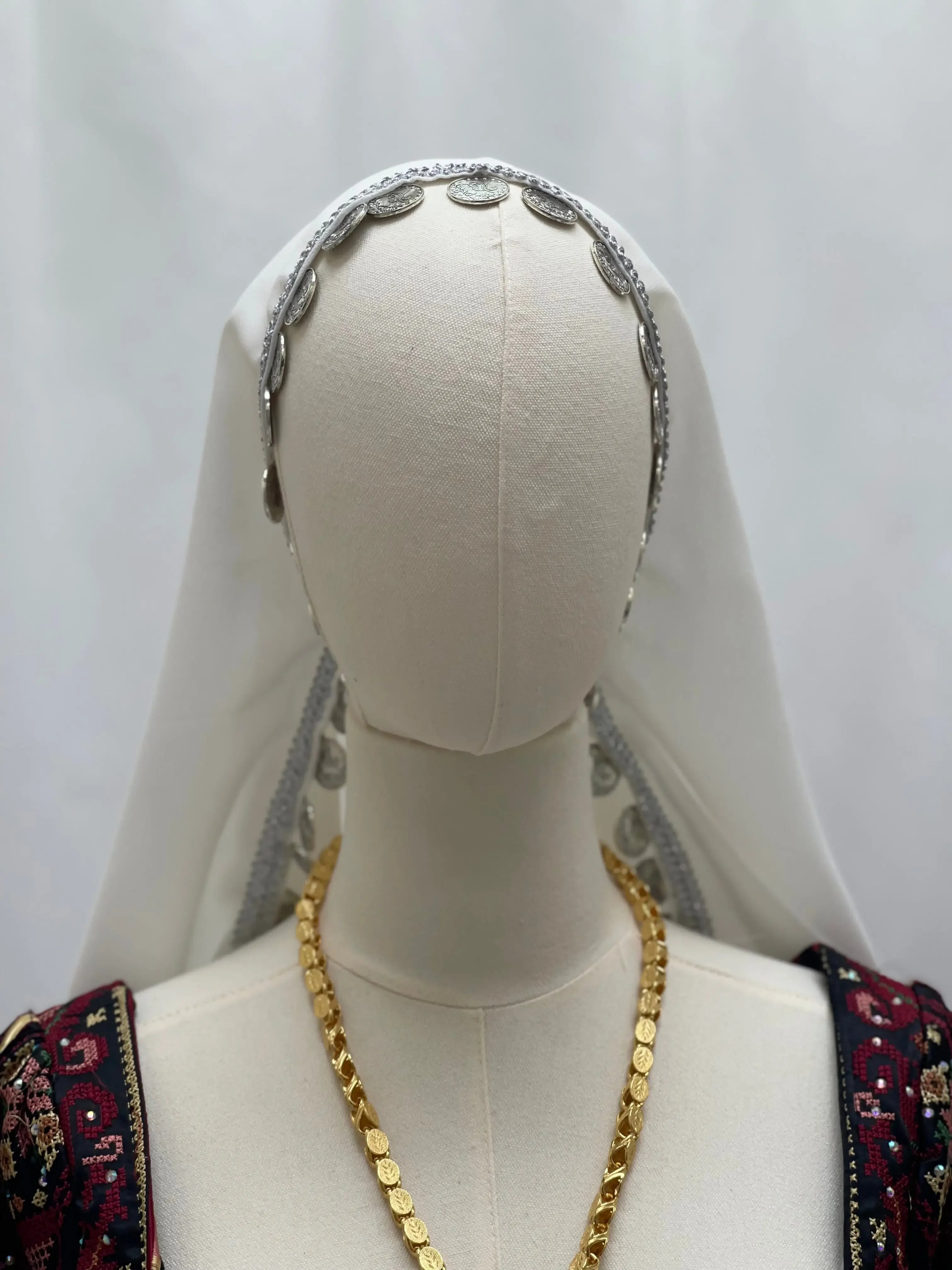 Khirka with gold coins accessory featuring traditional jewelry and detailed embroidery by Palestinian Elegance