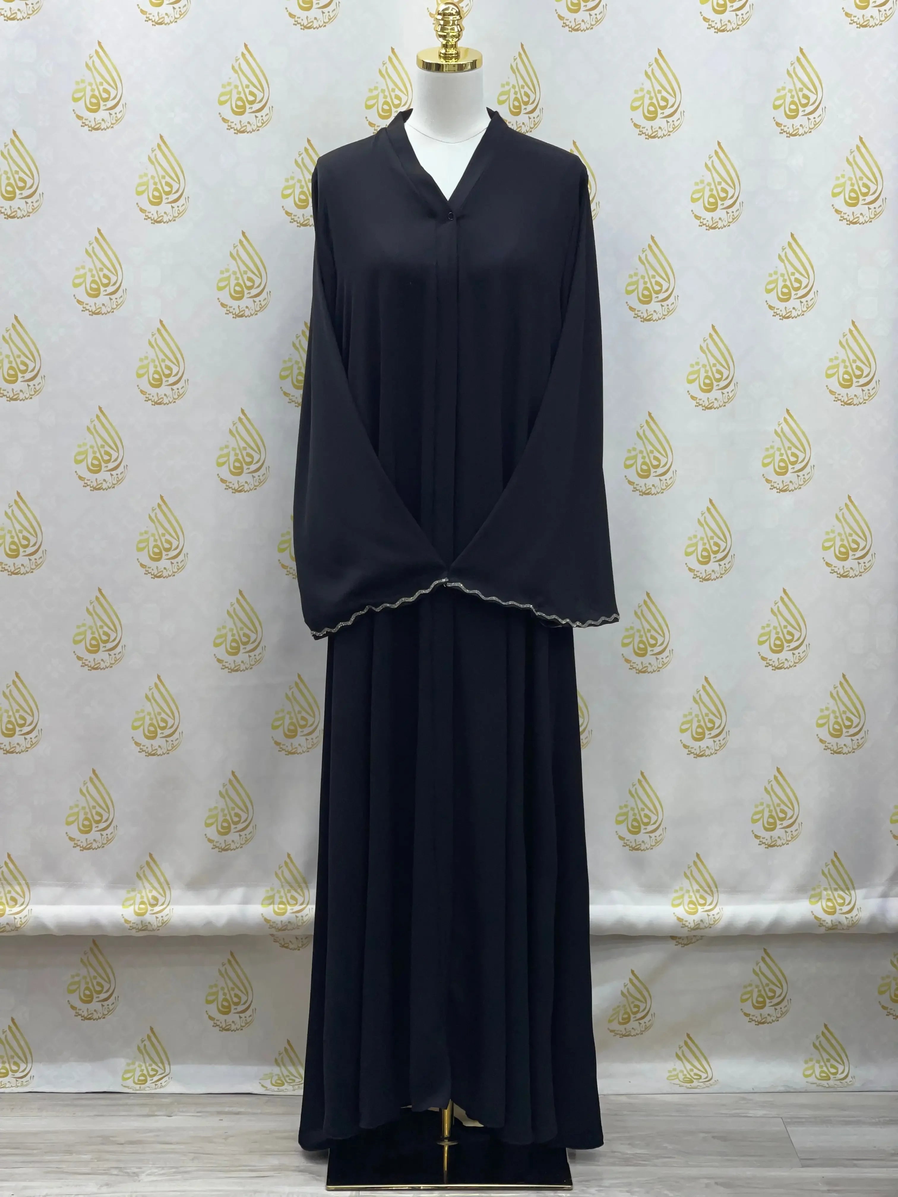 Palestinian Elegance luxurious cloche cut abaya in black with scalloped sleeve edges on mannequin