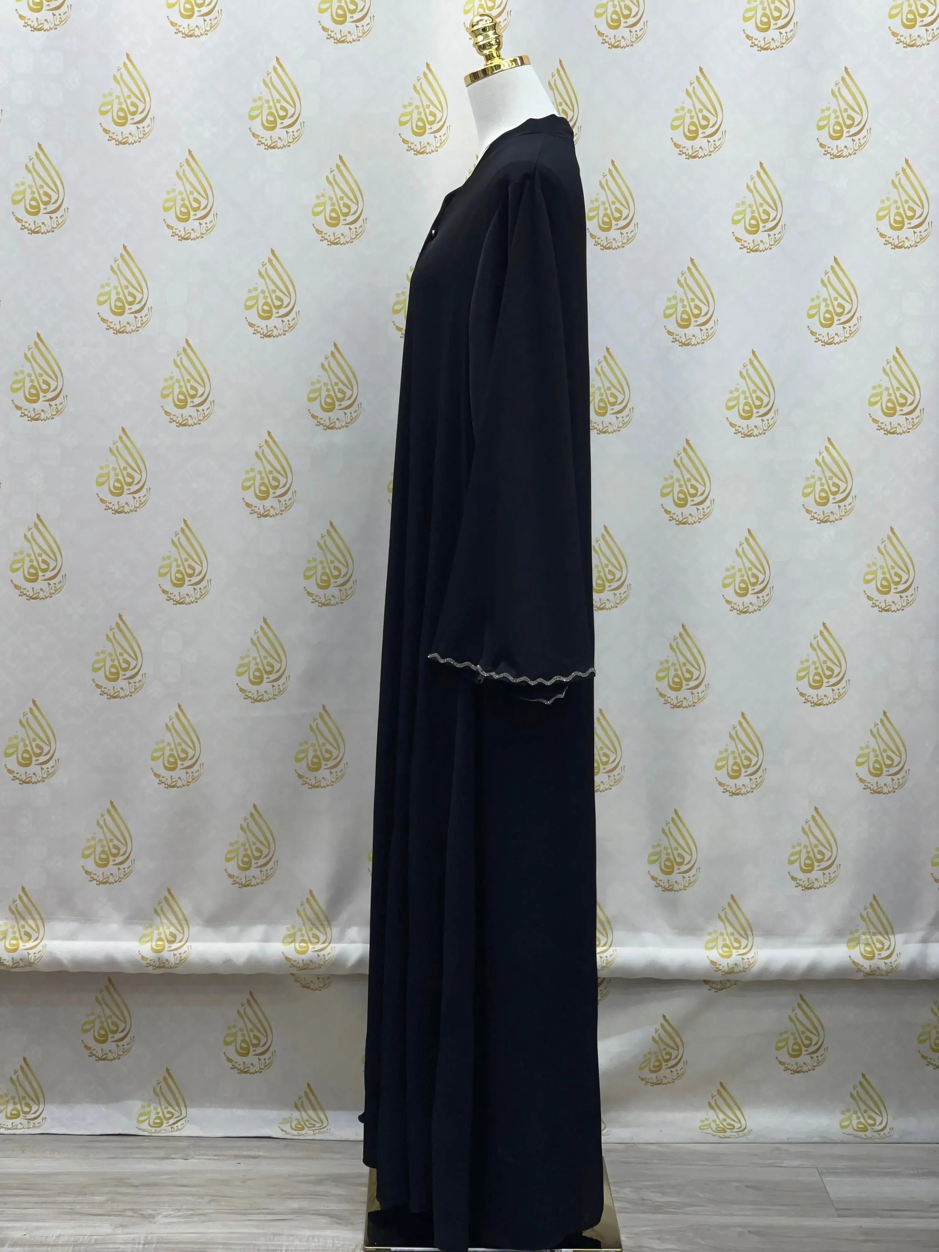 Palestinian Elegance luxurious cloche cut abaya in black displayed on mannequin side view