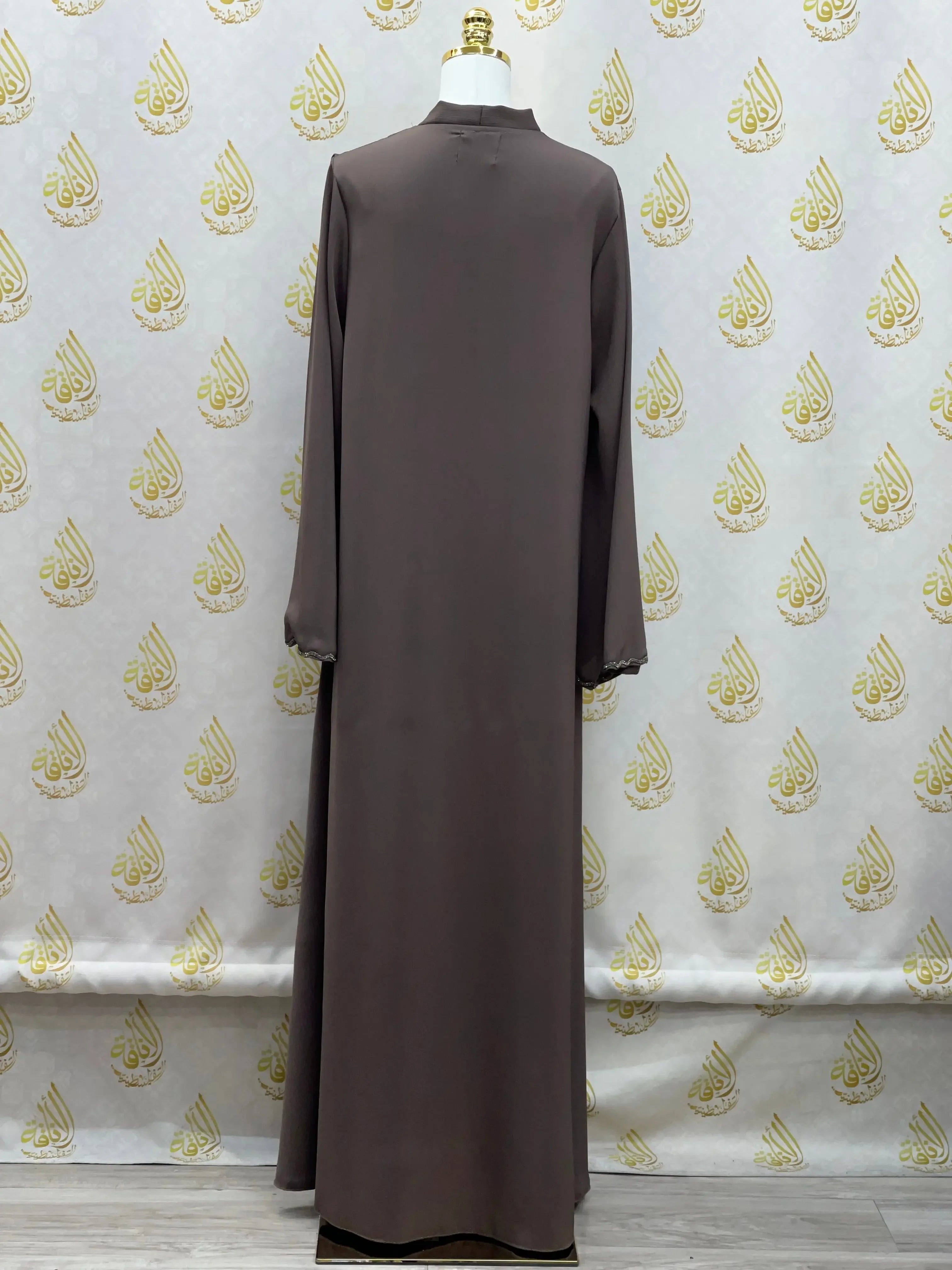 Palestinian Elegance luxurious cloche cut abaya in dark brown shown from the back with long sleeves