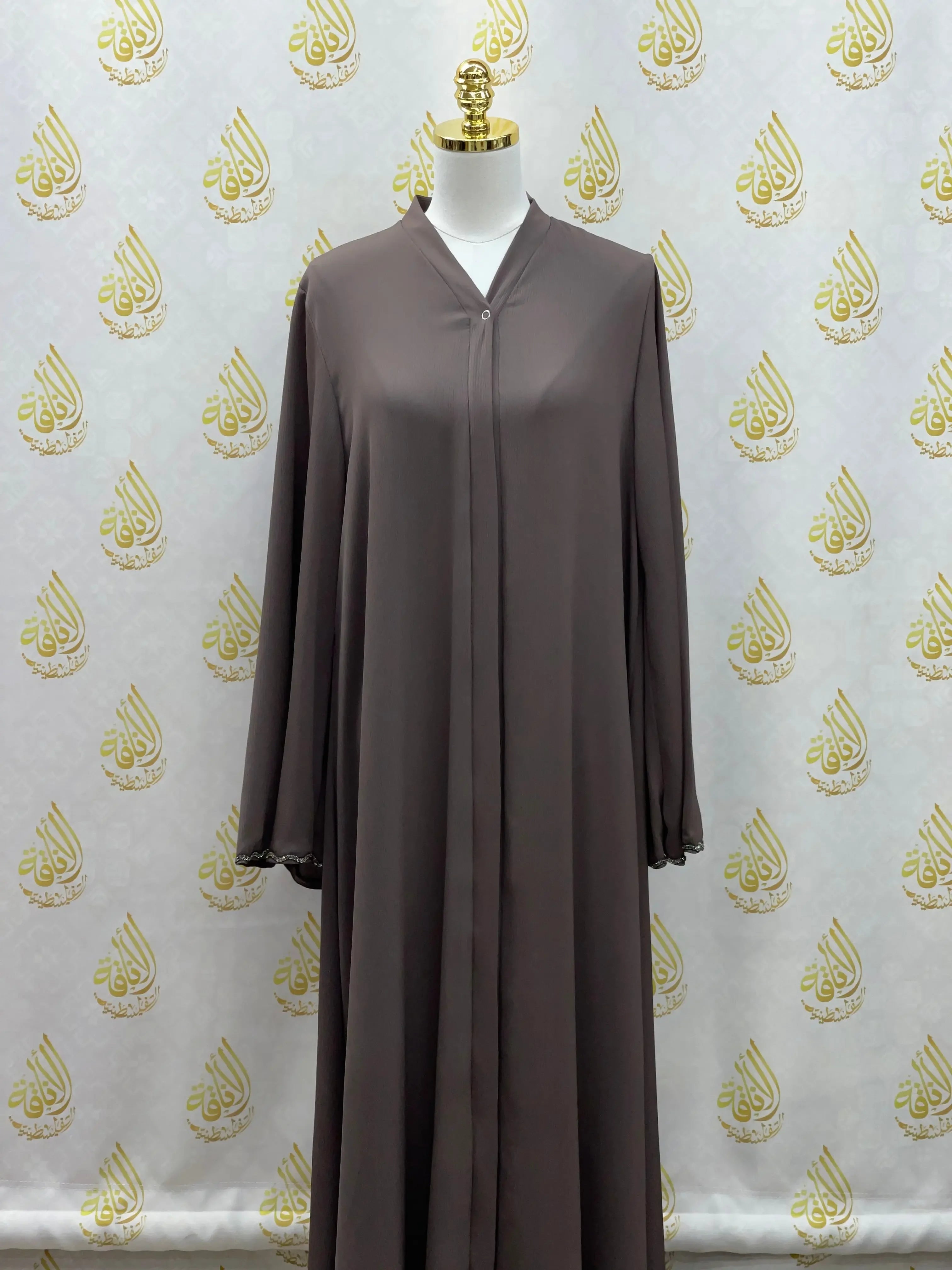 Palestinian Elegance luxurious cloche cut abaya in brown with long sleeves on mannequin