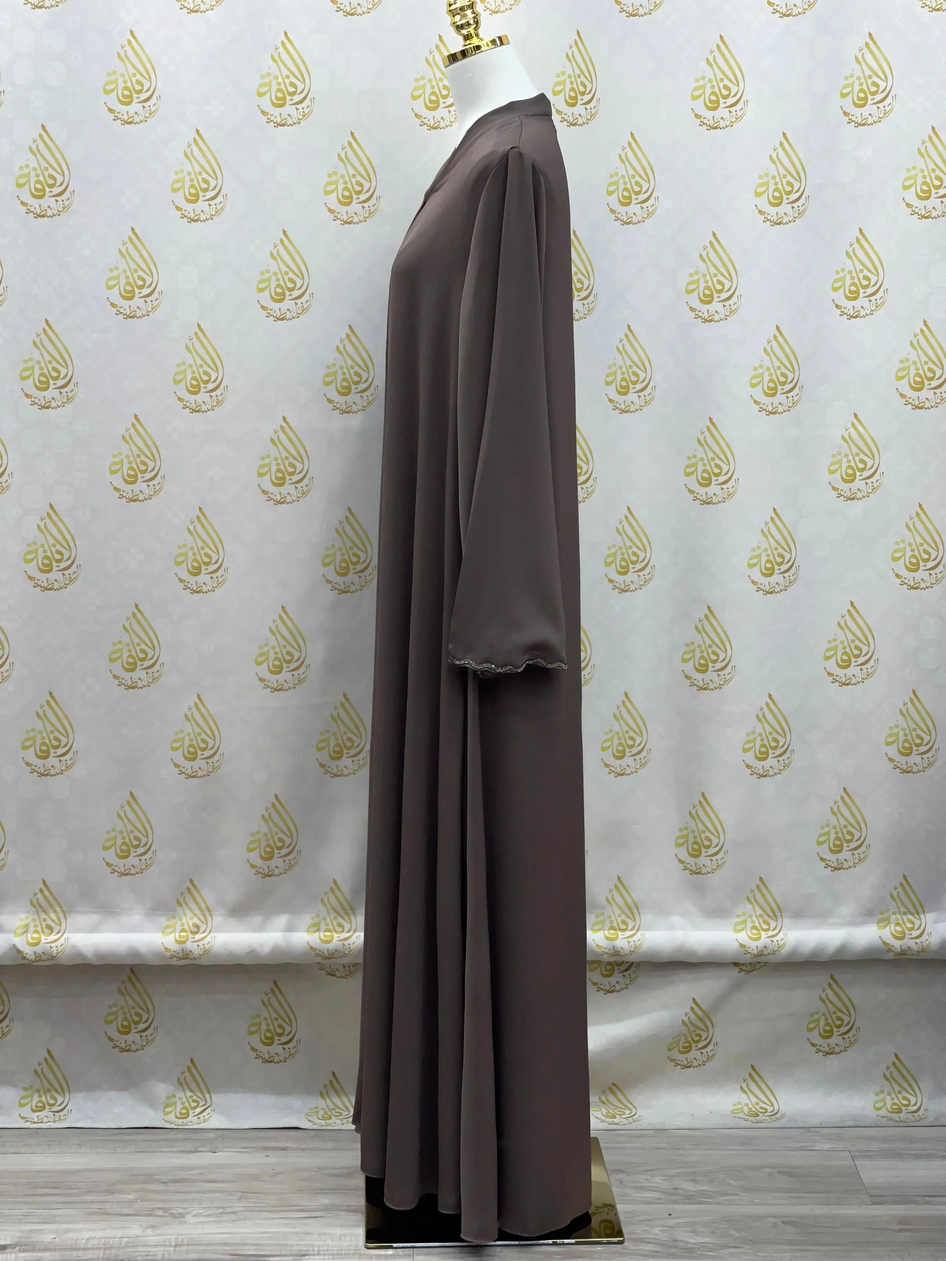 Palestinian Elegance luxurious cloche cut abaya in dark brown displayed on mannequin side view