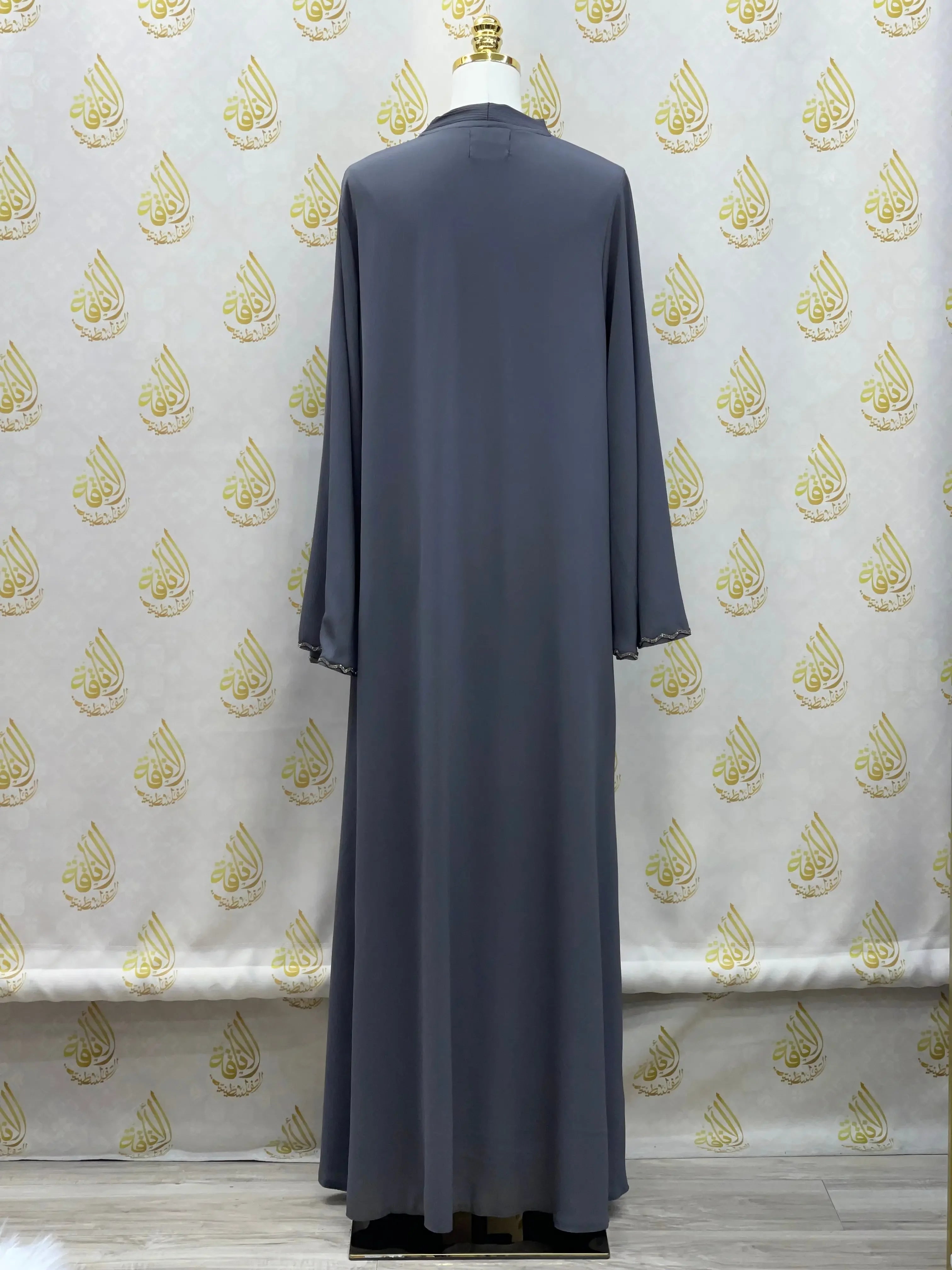 Back view of luxurious cloche cut abaya in dark gray by Palestinian Elegance on mannequin
