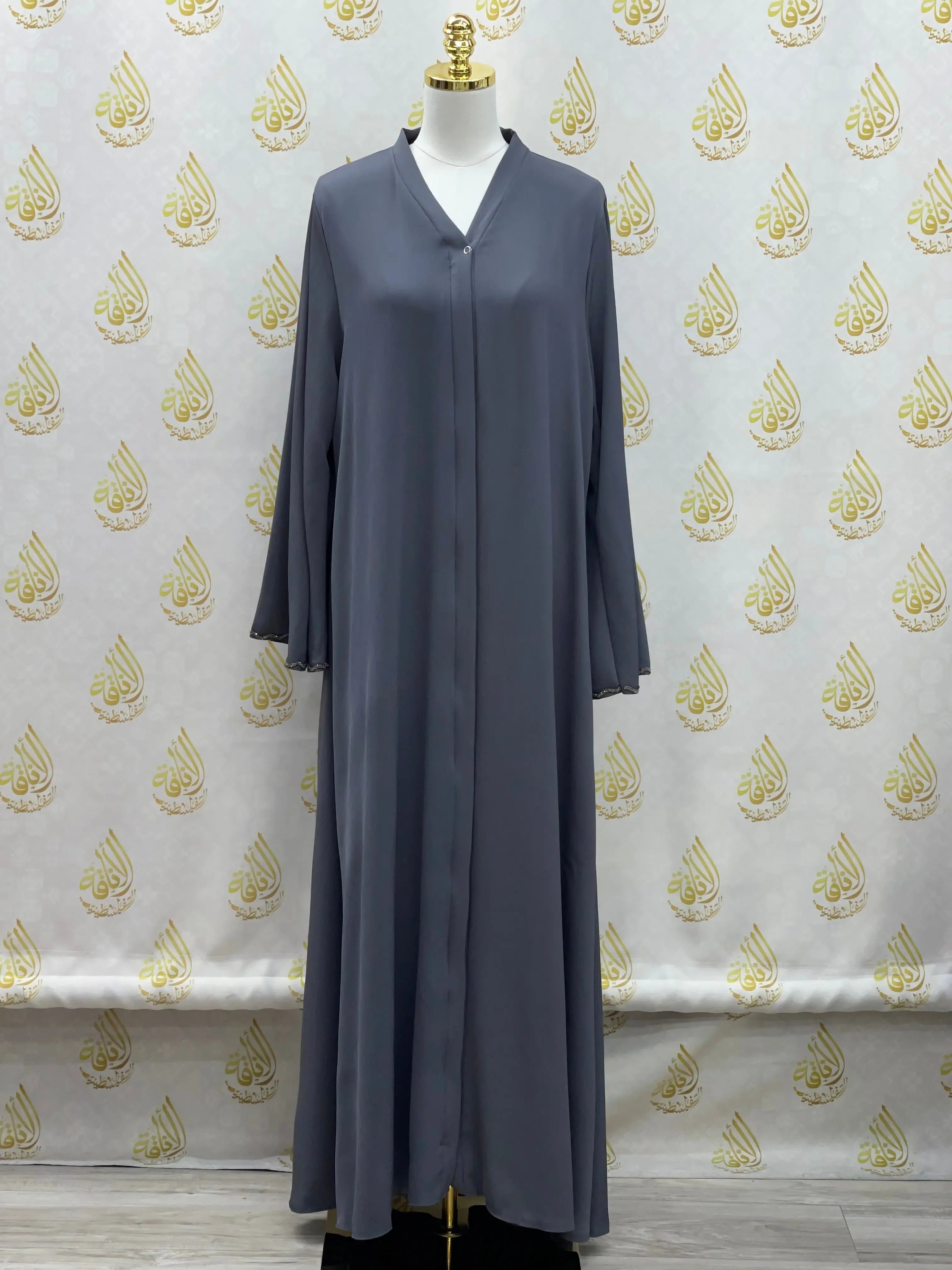 Palestinian Elegance luxurious cloche cut abaya in dark gray with long sleeves on mannequin