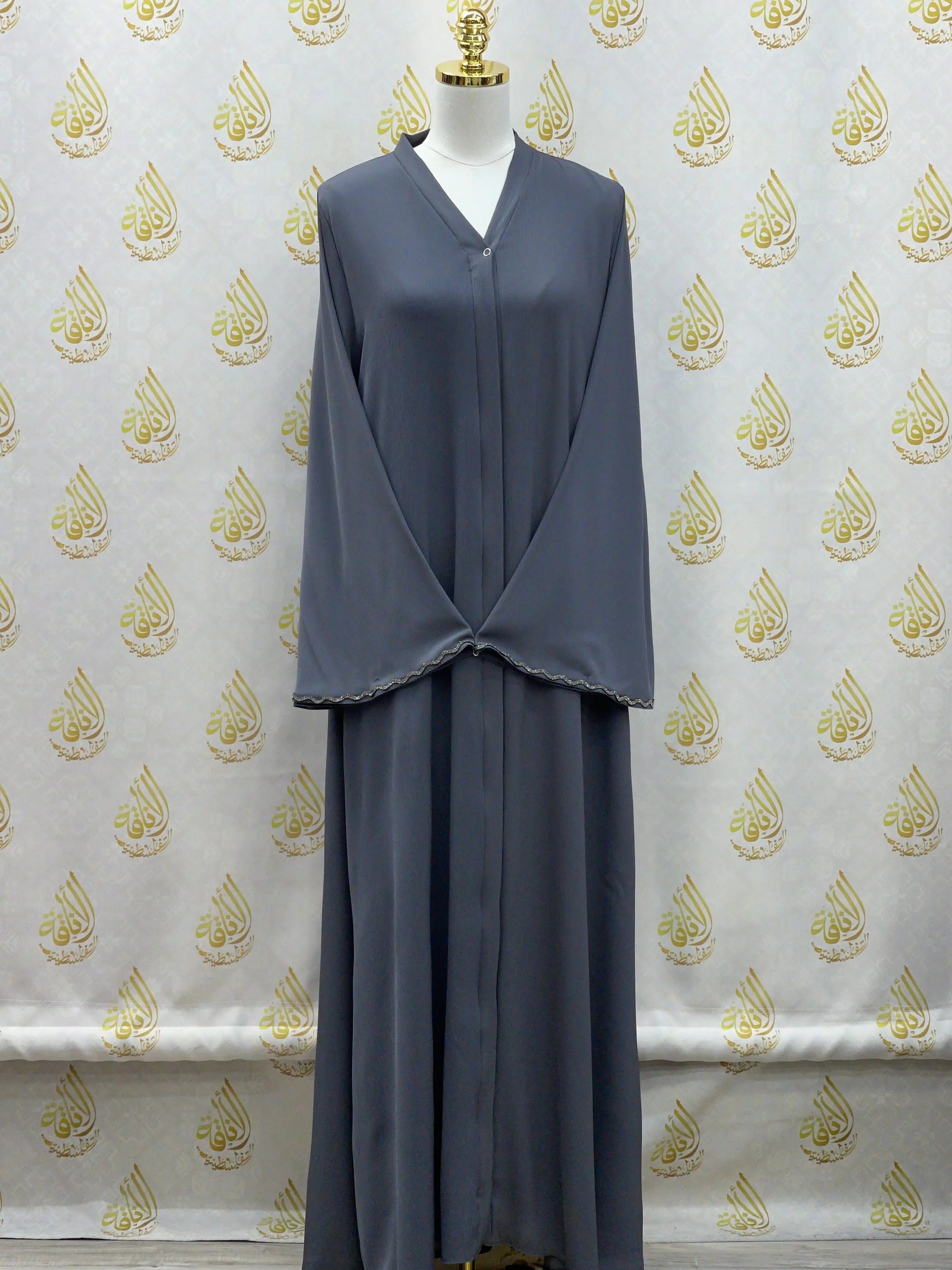 Palestinian Elegance luxurious cloche cut abaya in gray with long sleeves displayed on mannequin