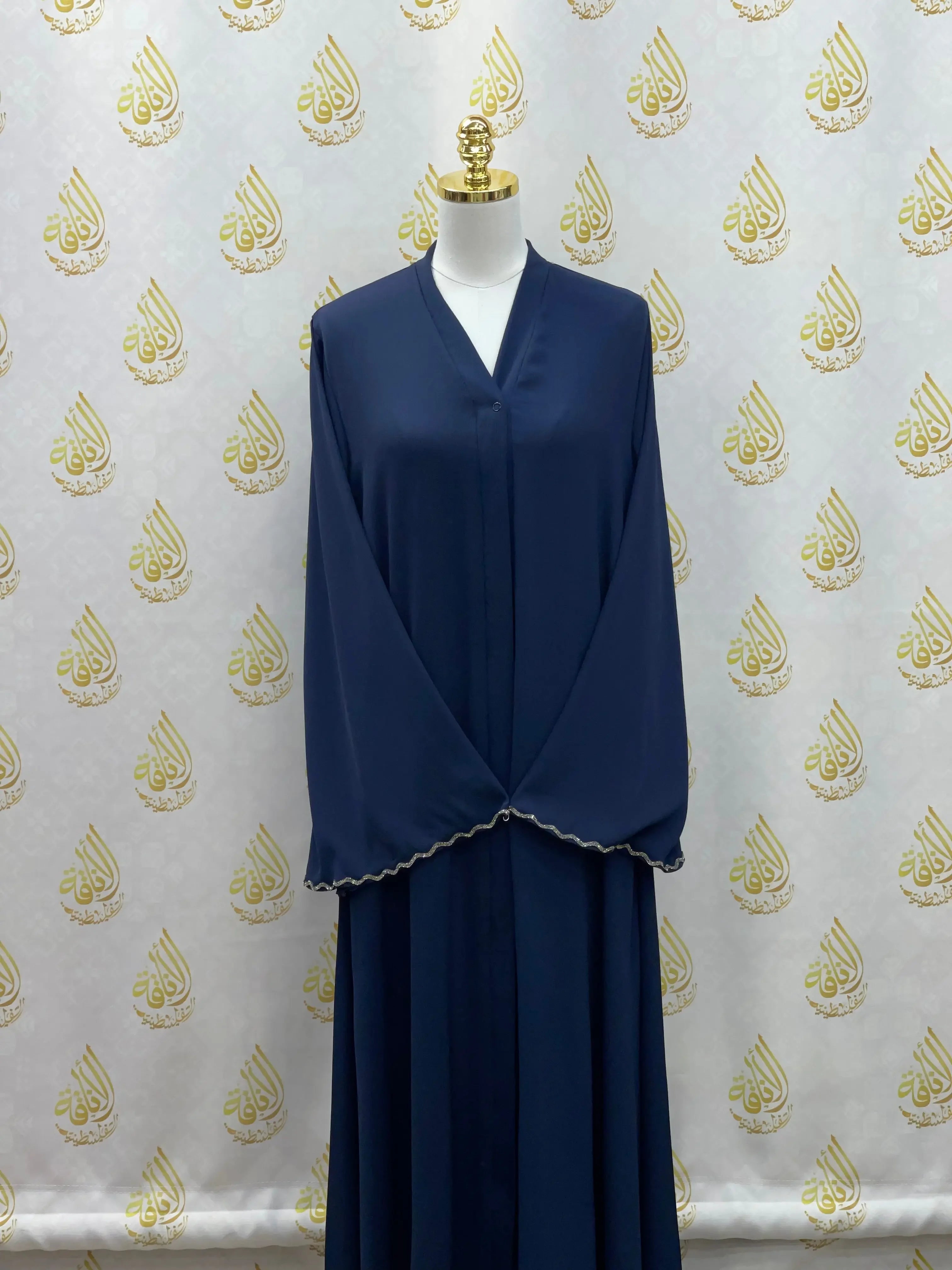 Palestinian Elegance luxurious cloche cut abaya in deep navy with scalloped sleeve edges on mannequin
