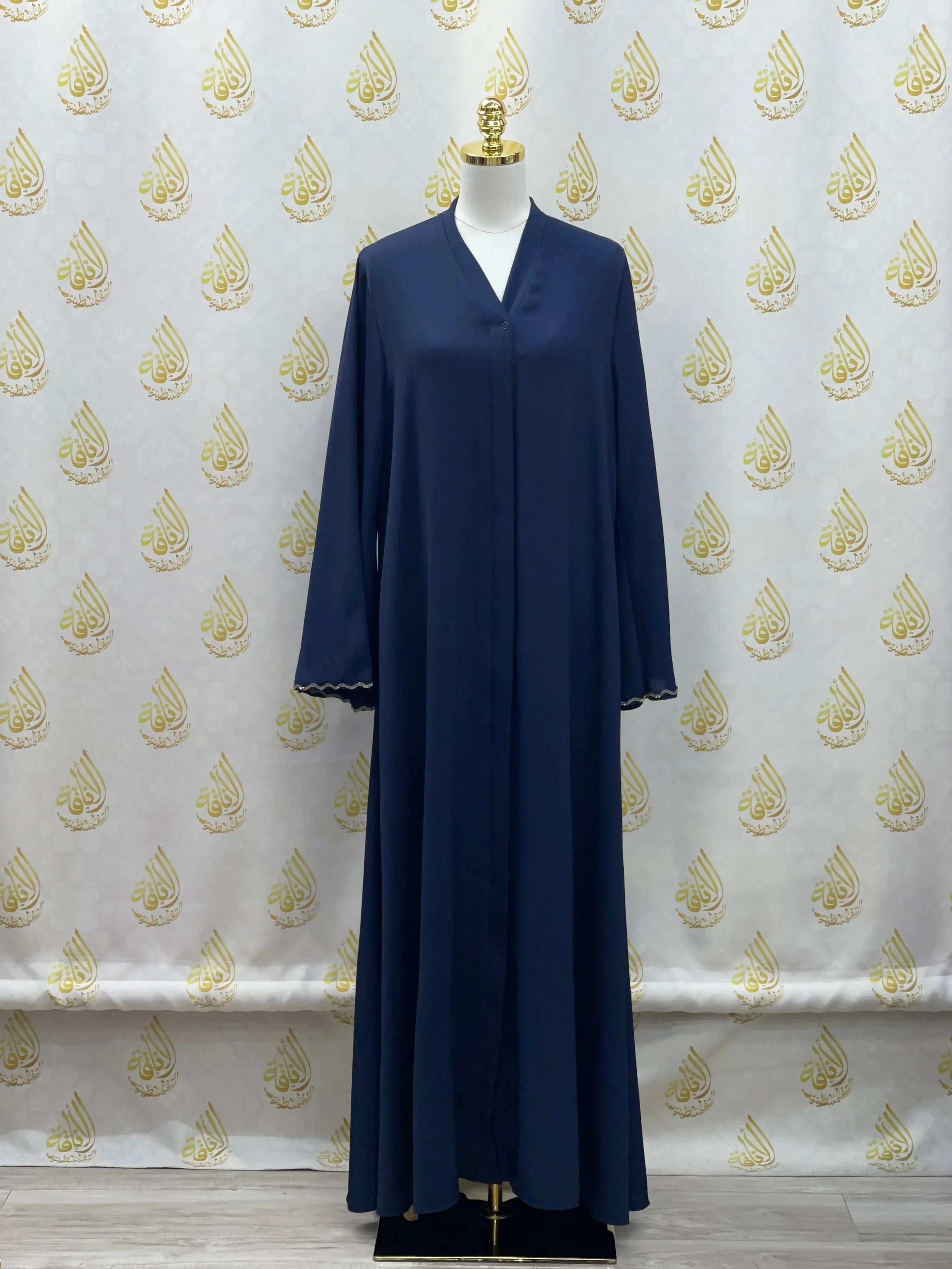 Navy blue luxurious cloche cut abaya by Palestinian Elegance displayed on a mannequin