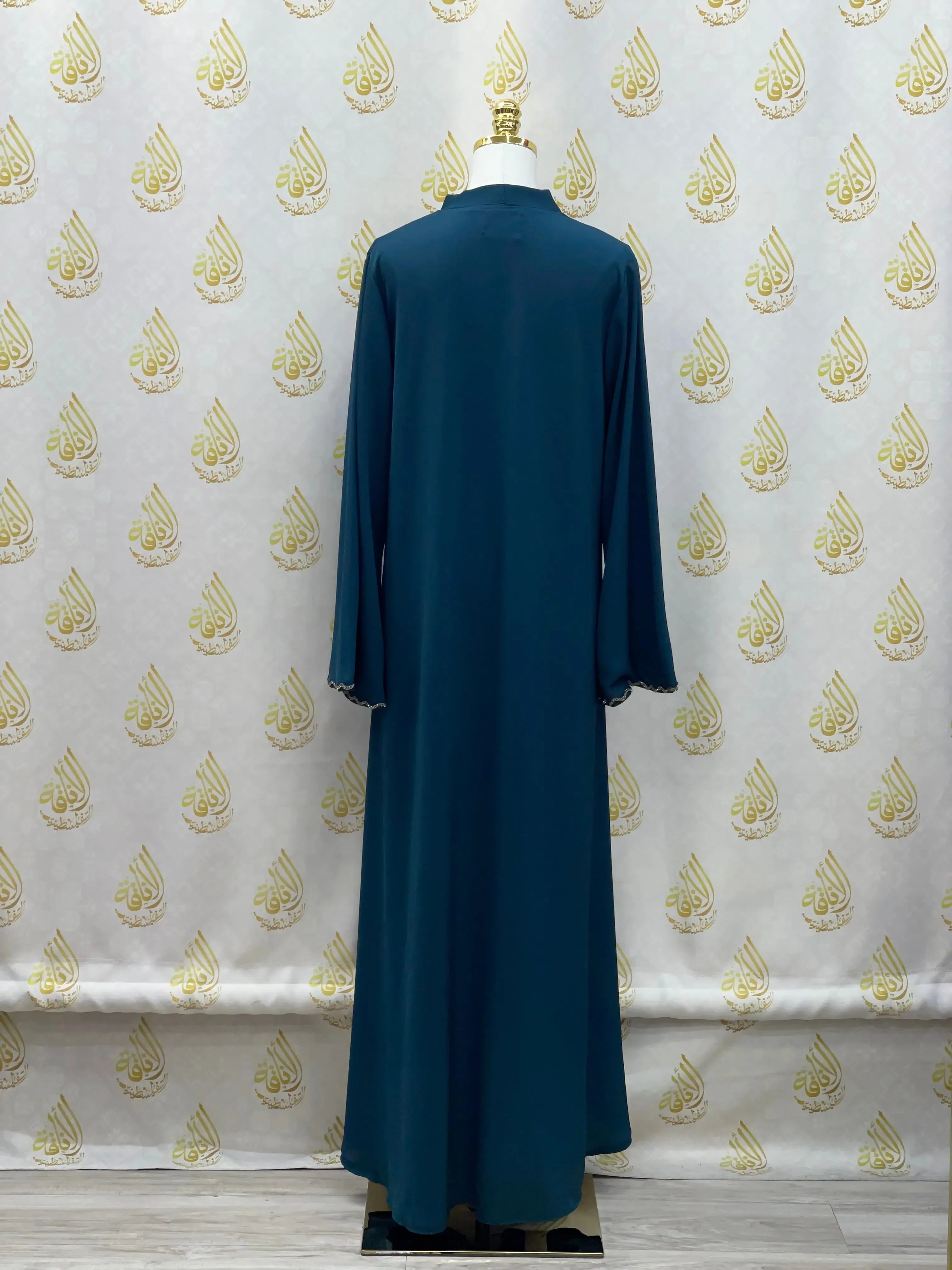 Palestinian Elegance luxurious cloche cut abaya in deep blue displayed on mannequin from back