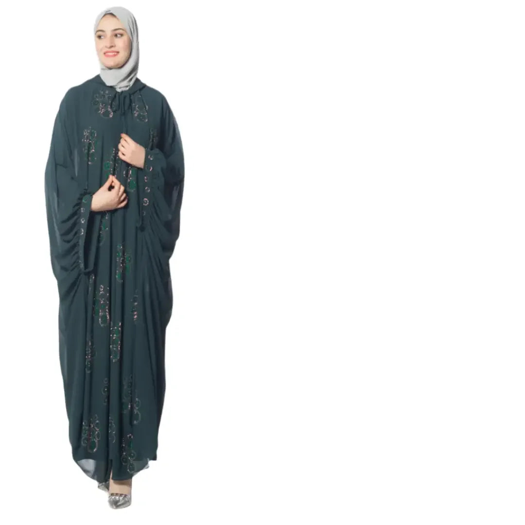 Luxury Palestinian abaya by Palestinian Elegance with intricate embroidery worn by woman with light gray hijab