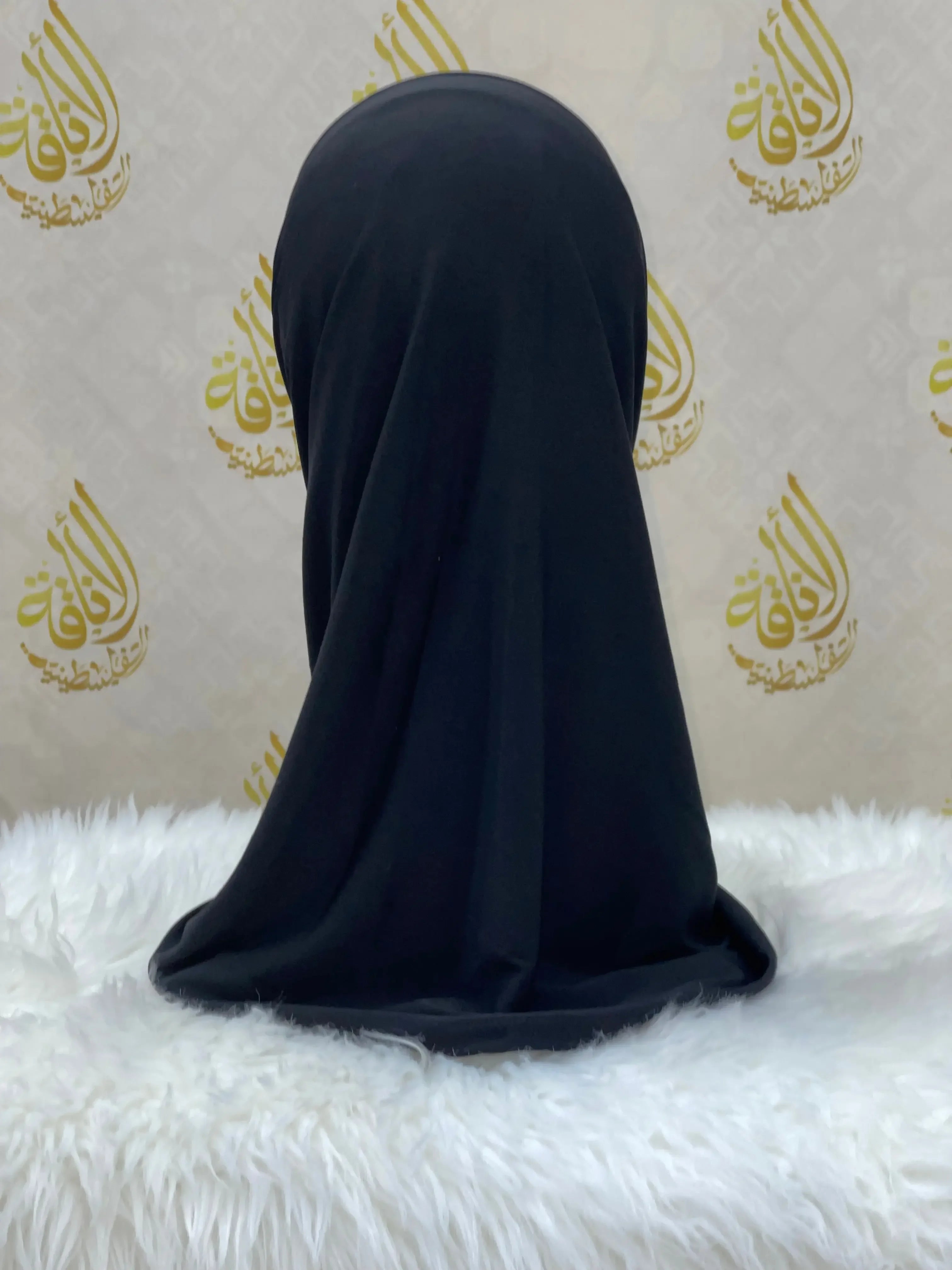 Black lycra hijab for women displayed on a mannequin by Palestinian Elegance