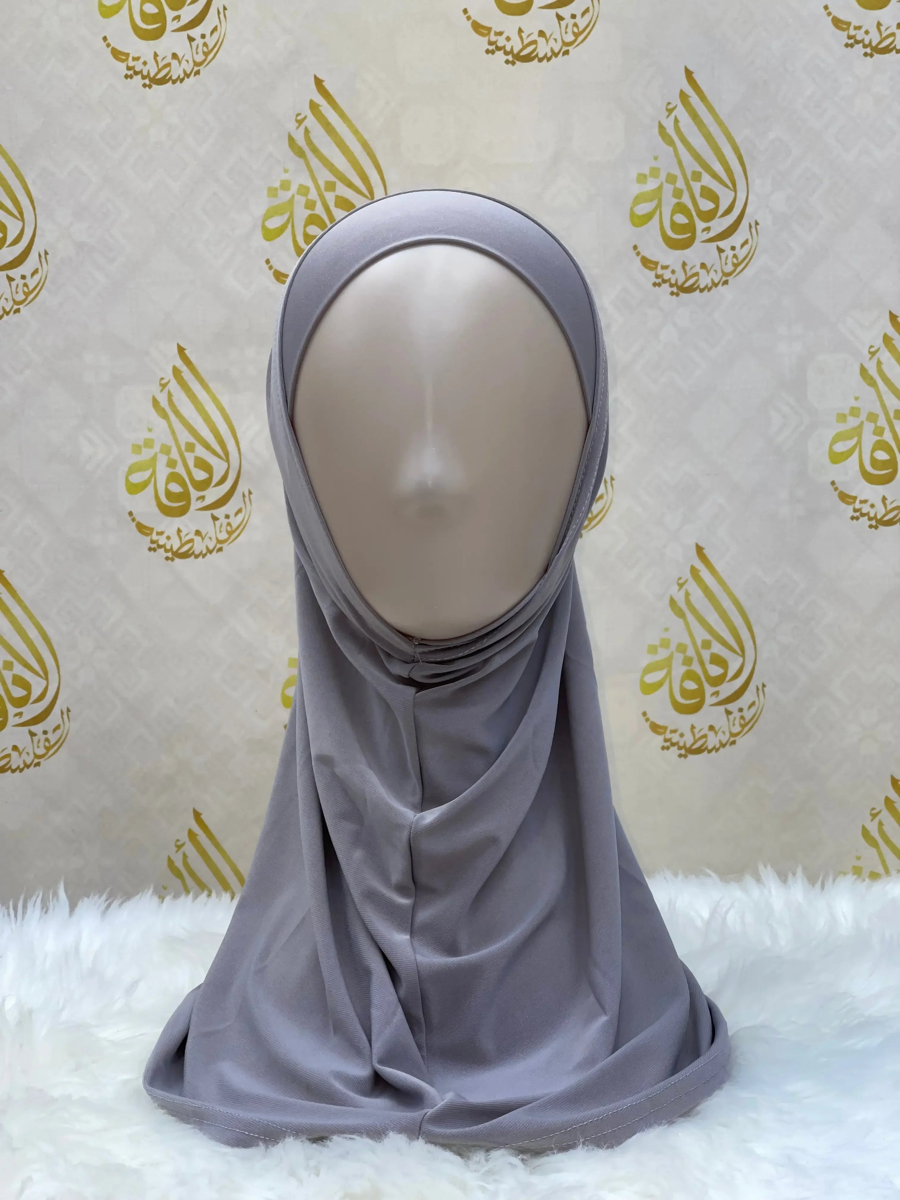 Gray lycra hijab for women displayed on a mannequin by Palestinian Elegance