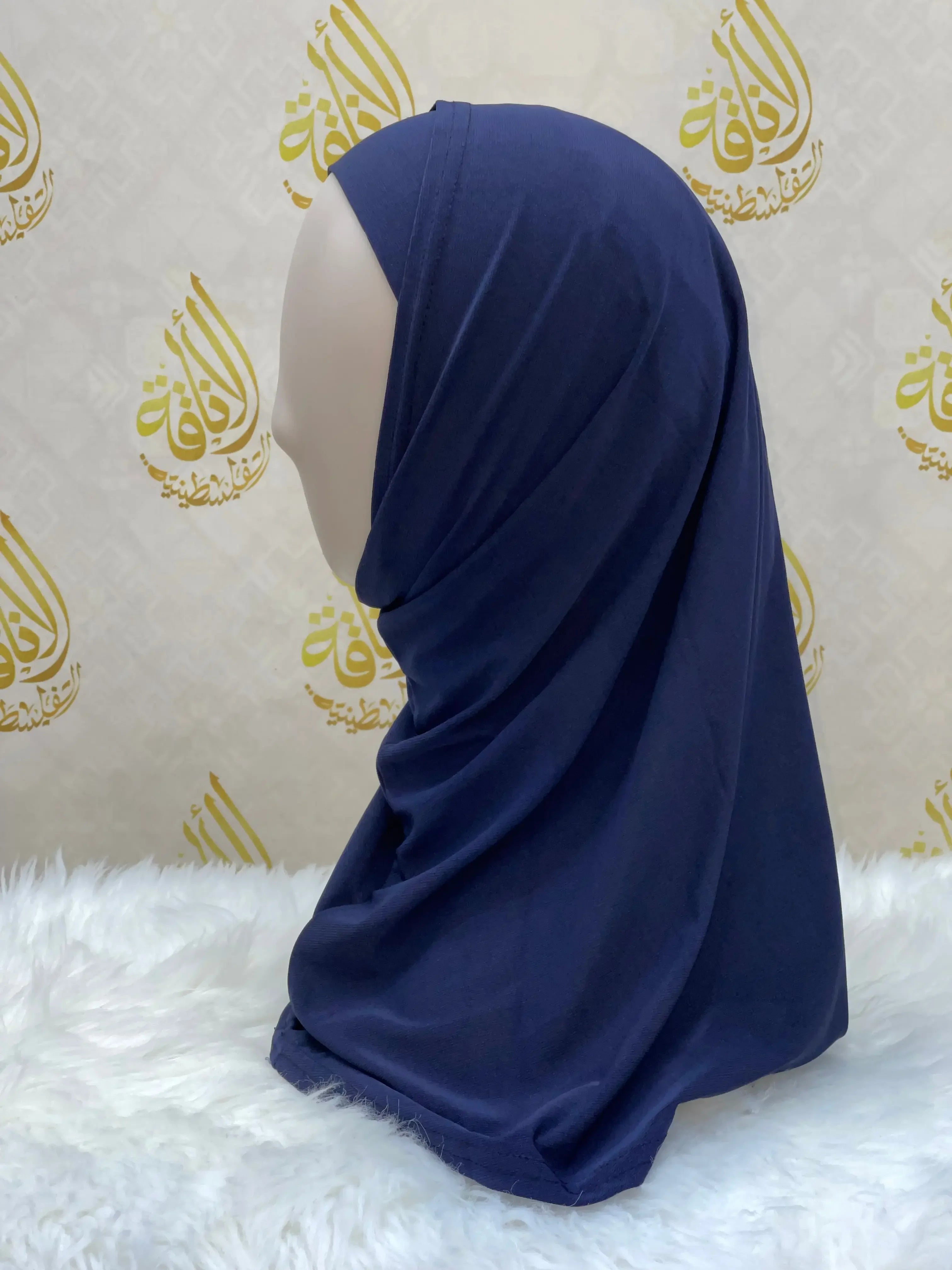 Palestinian Elegance navy blue lycra hijab for women displayed on mannequin with white fur background