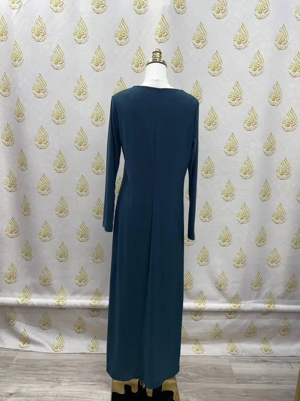 Back view of a long sleeve dark blue lycra inner dress for women displayed on a mannequin