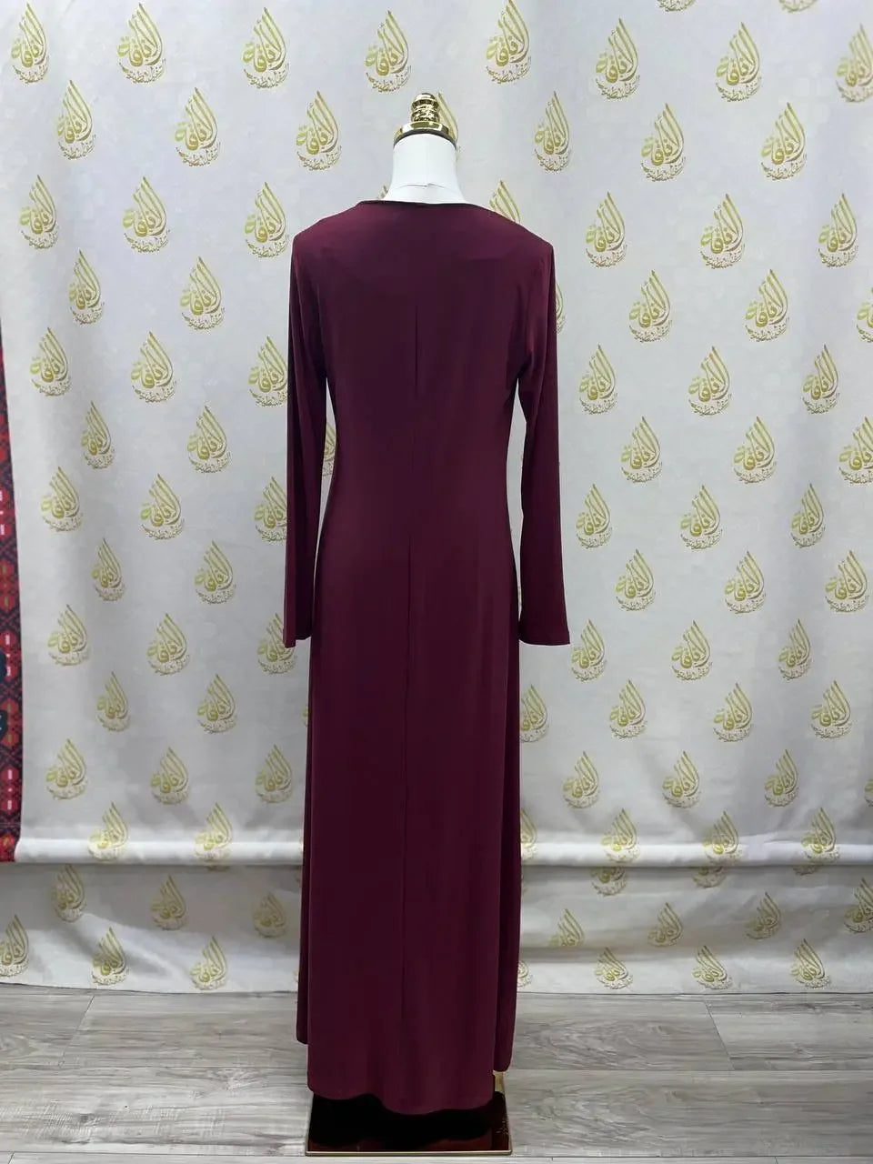 Back view of a long-sleeve burgundy lycra inner dress for women by Palestinian Elegance on a mannequin
