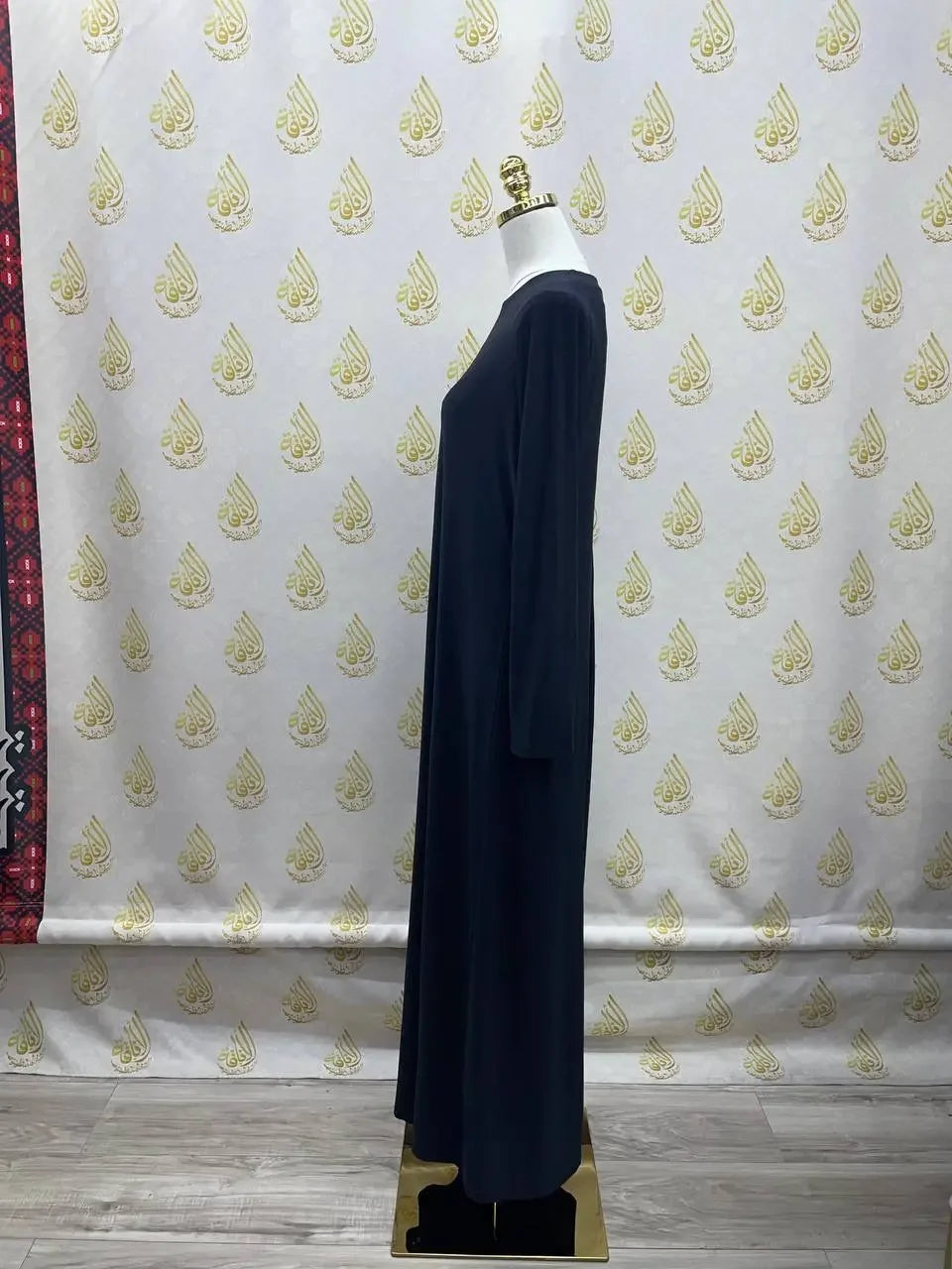 Black long sleeve lycra inner dress for women displayed on mannequin by Palestinian Elegance