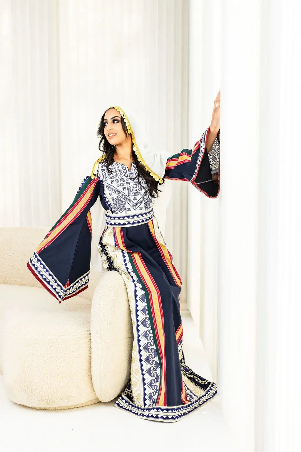 Majdalawi thoub dress by Palestinian Elegance featuring traditional embroidery on flowing sleeves and striped design