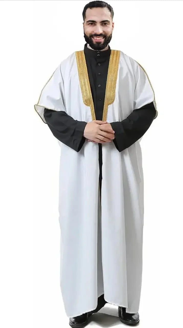 Men's cotton abaya bisht in white with gold trim worn over black traditional garment