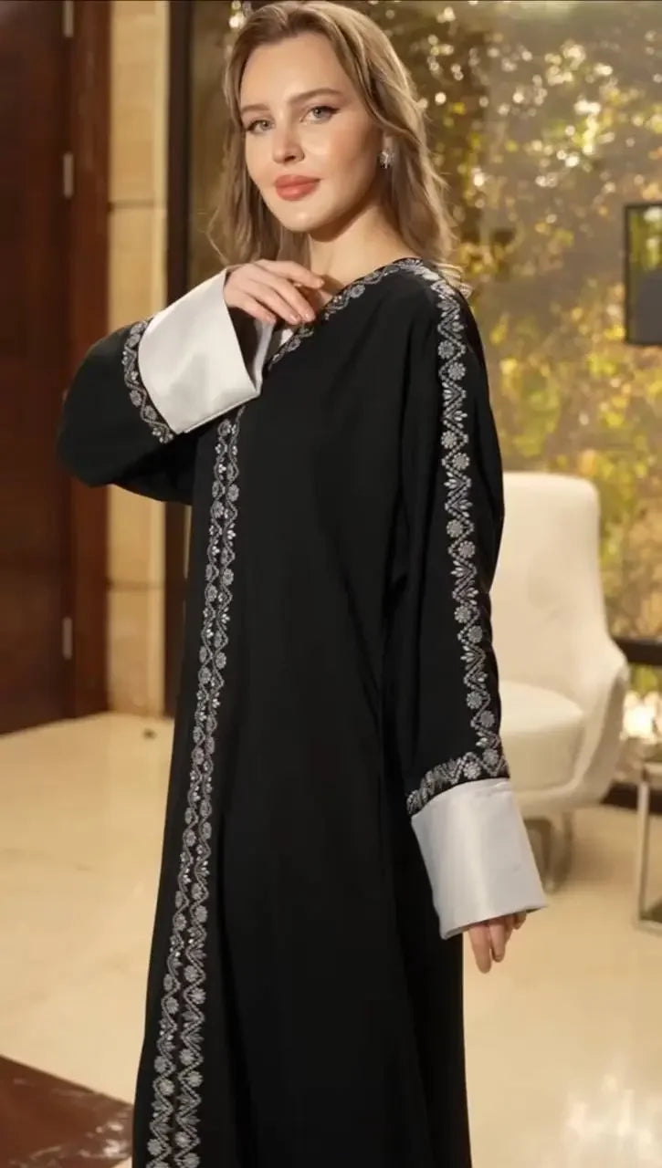 Palestinian Elegance modern abaya for women in black with white embroidered trim and wide cuffs