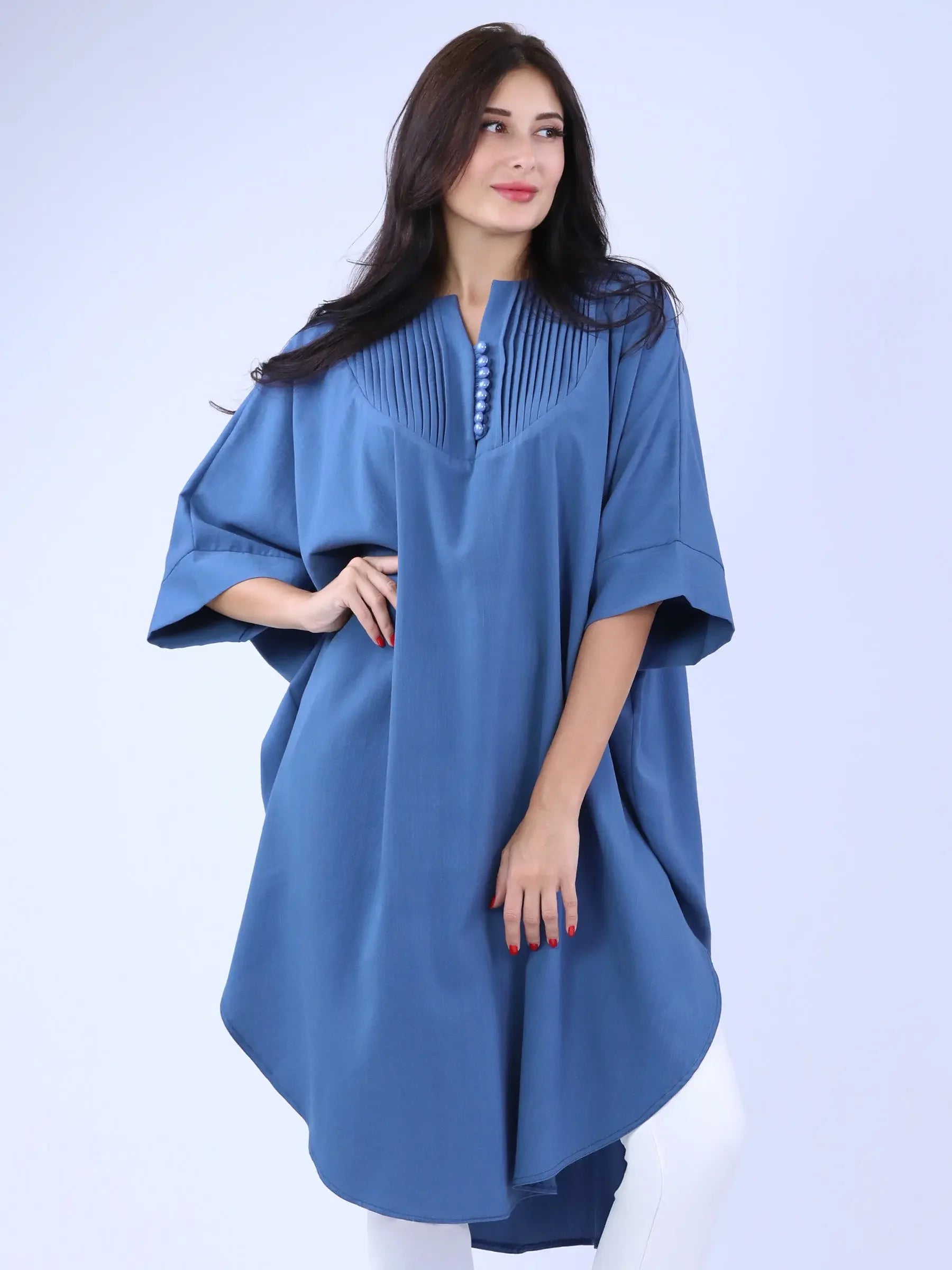 Palestinian Elegance blue modest cape top with pleated details and button accents on model